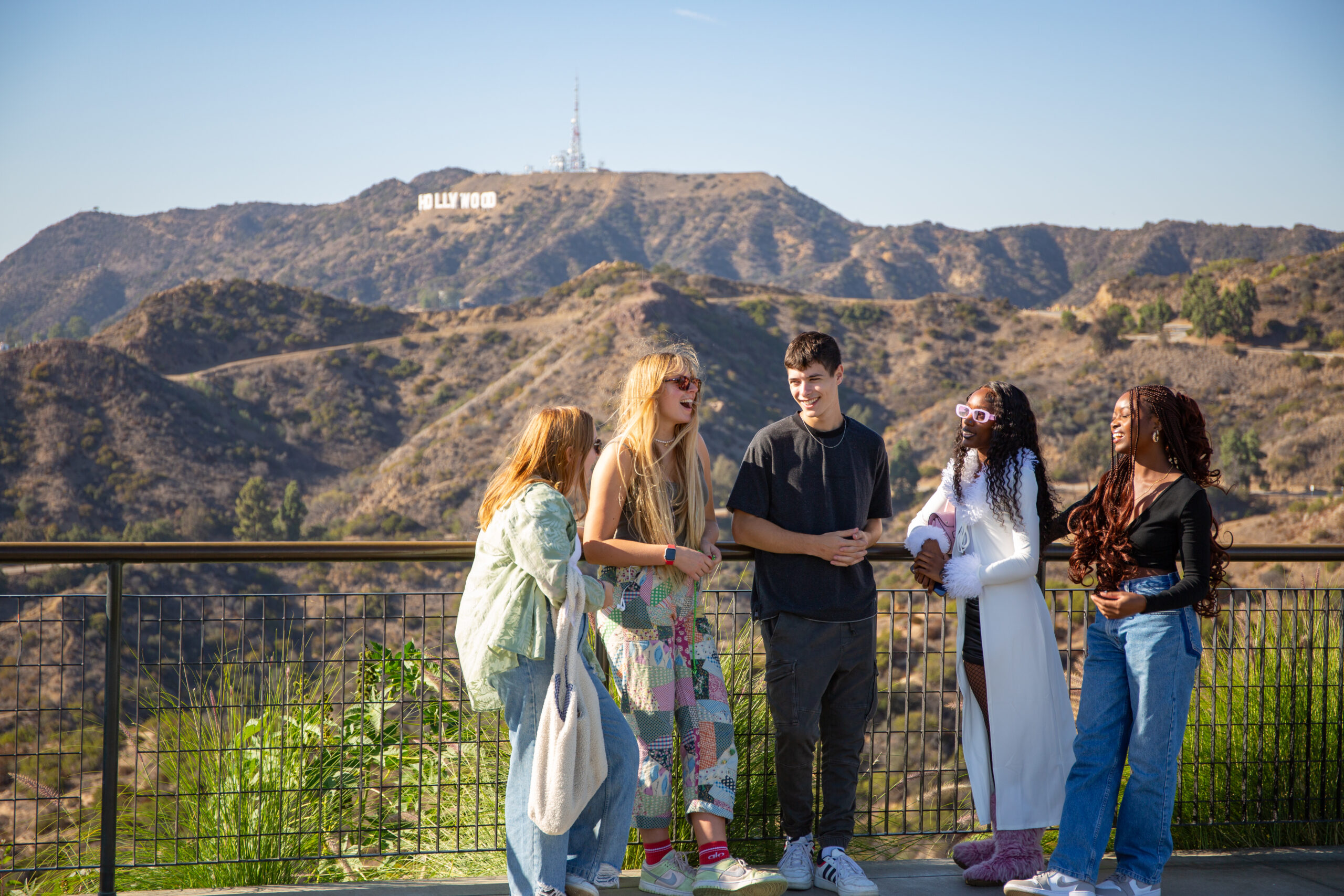 A group of students hanging out in LA. The Hollywood sign is visible in the distance.