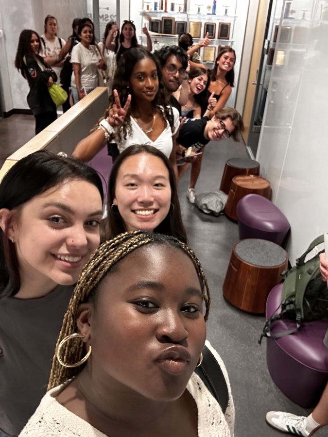 A group of NYU students take a selfie together.