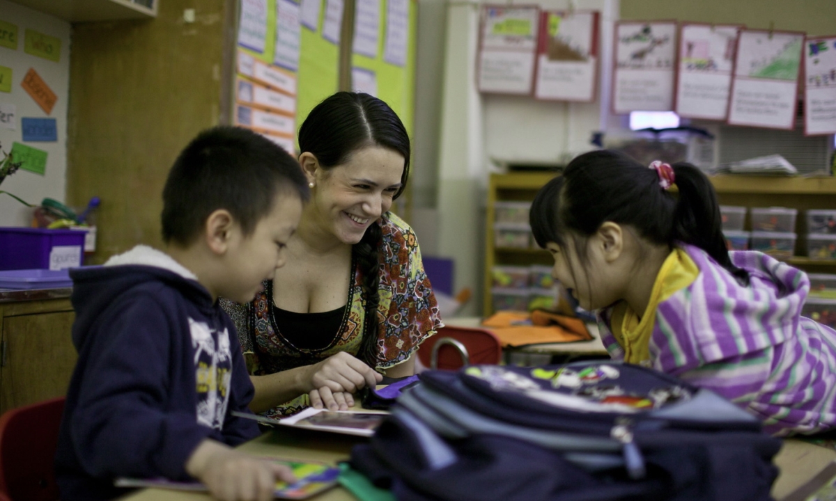An NYU student interacting with children during their student teaching experience.