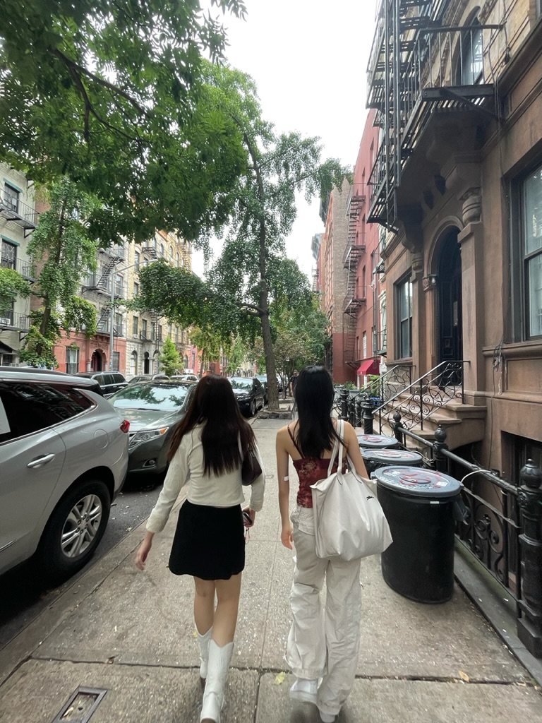 Yasmin and a friend walking down the street in New York City.