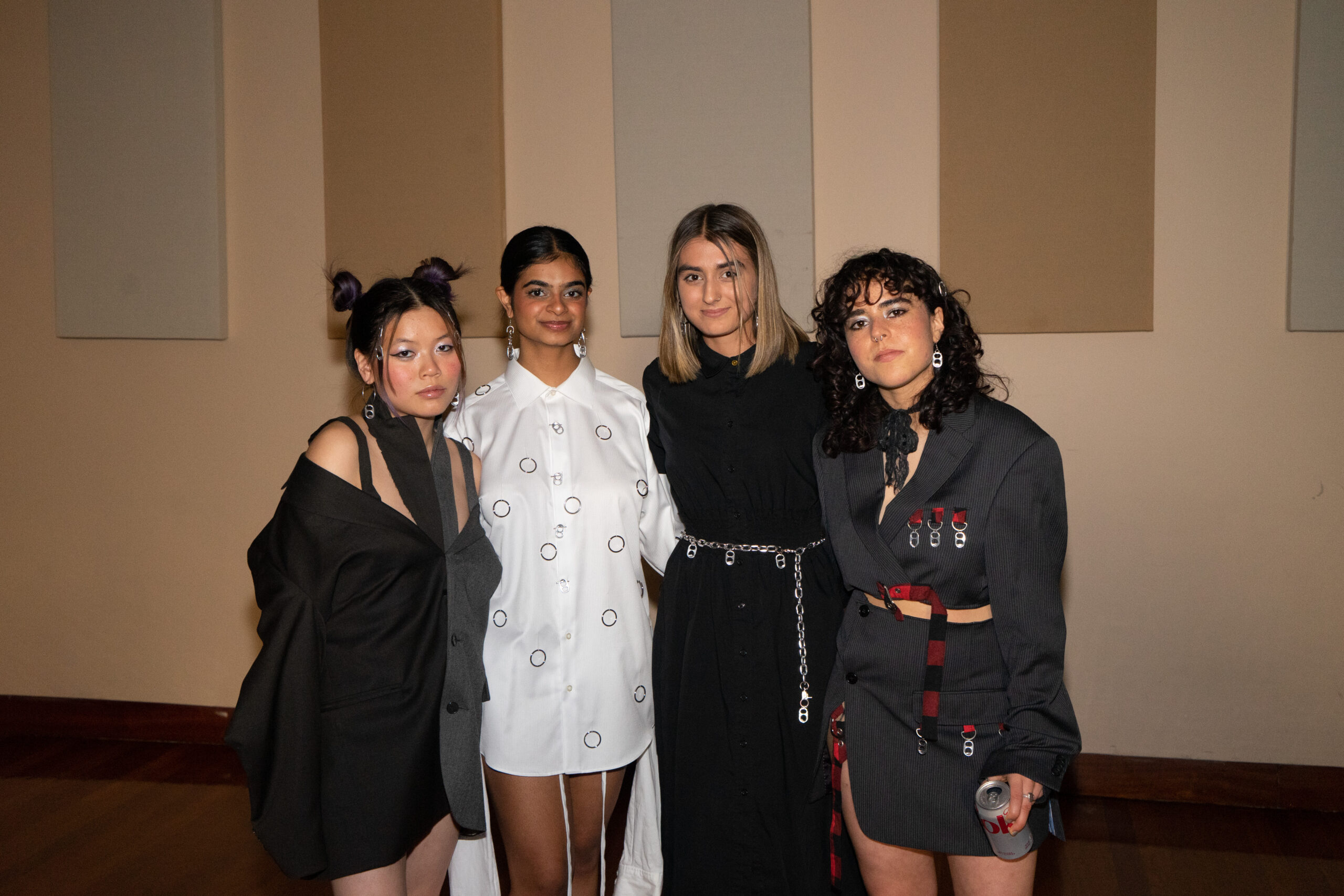 A group of female-presenting student in designs showcased at the NYU Re-Fashion Show.