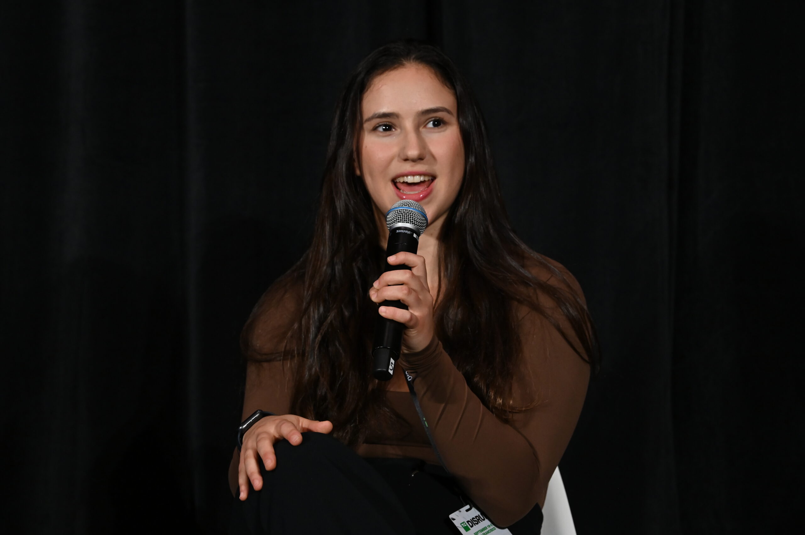 Tandon student Alexandra Debow speaks into a microphone at TechCrunch Disrupt.