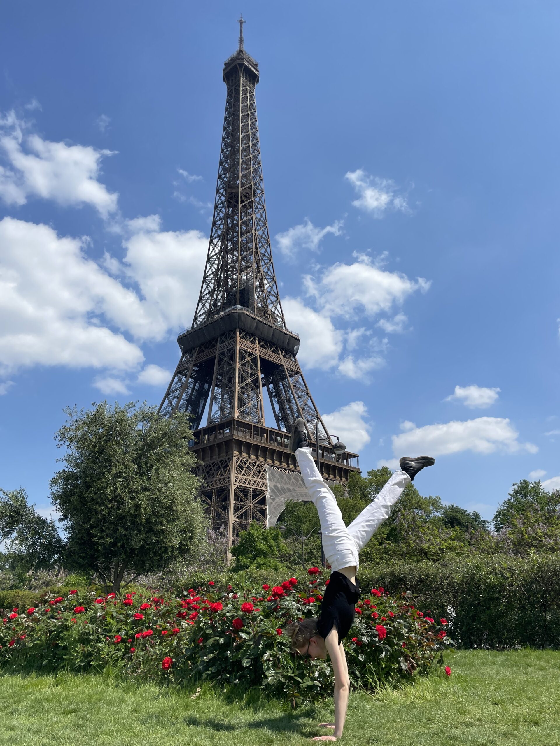 NYU homestay student Devyn doing a handstand in front of the Eiffel Tower.
