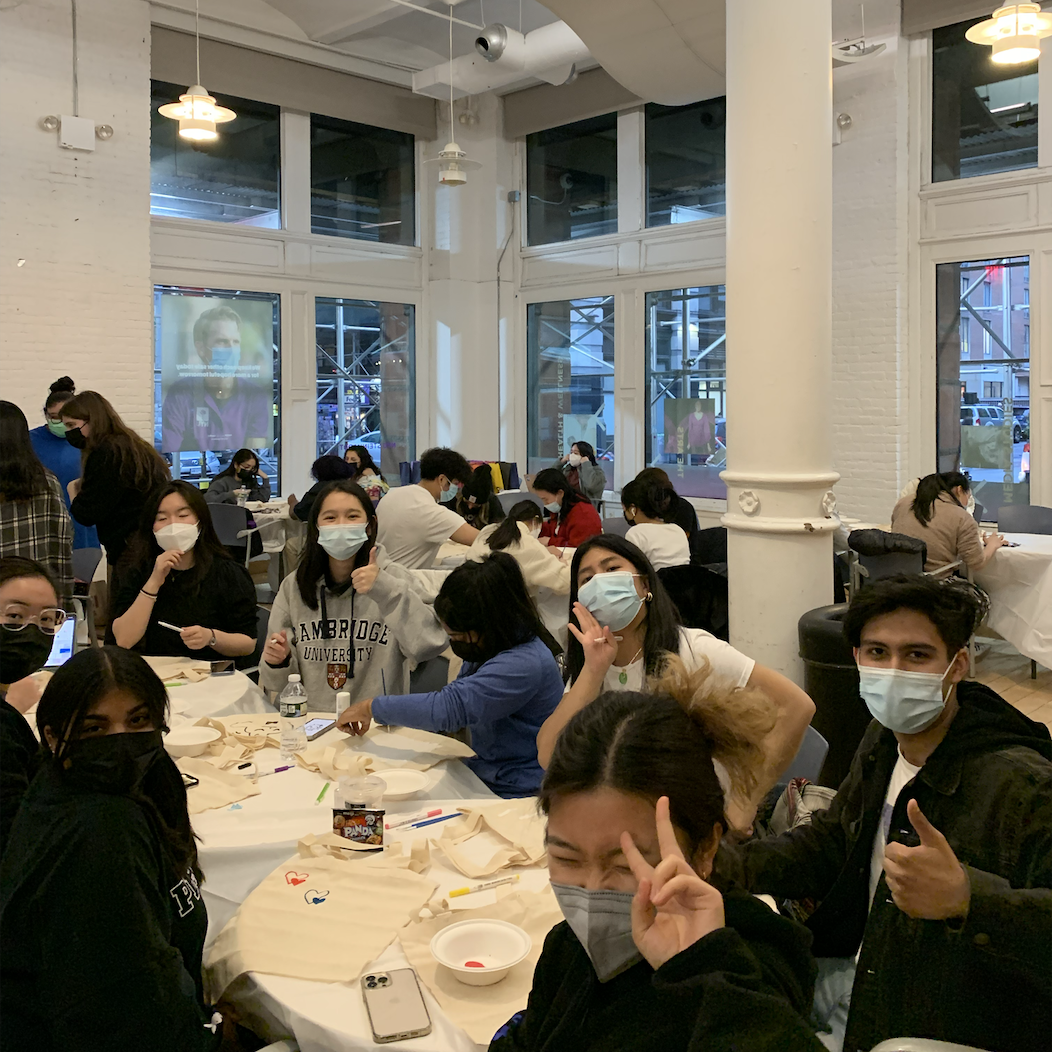 Students sitting a table with face masks on.
