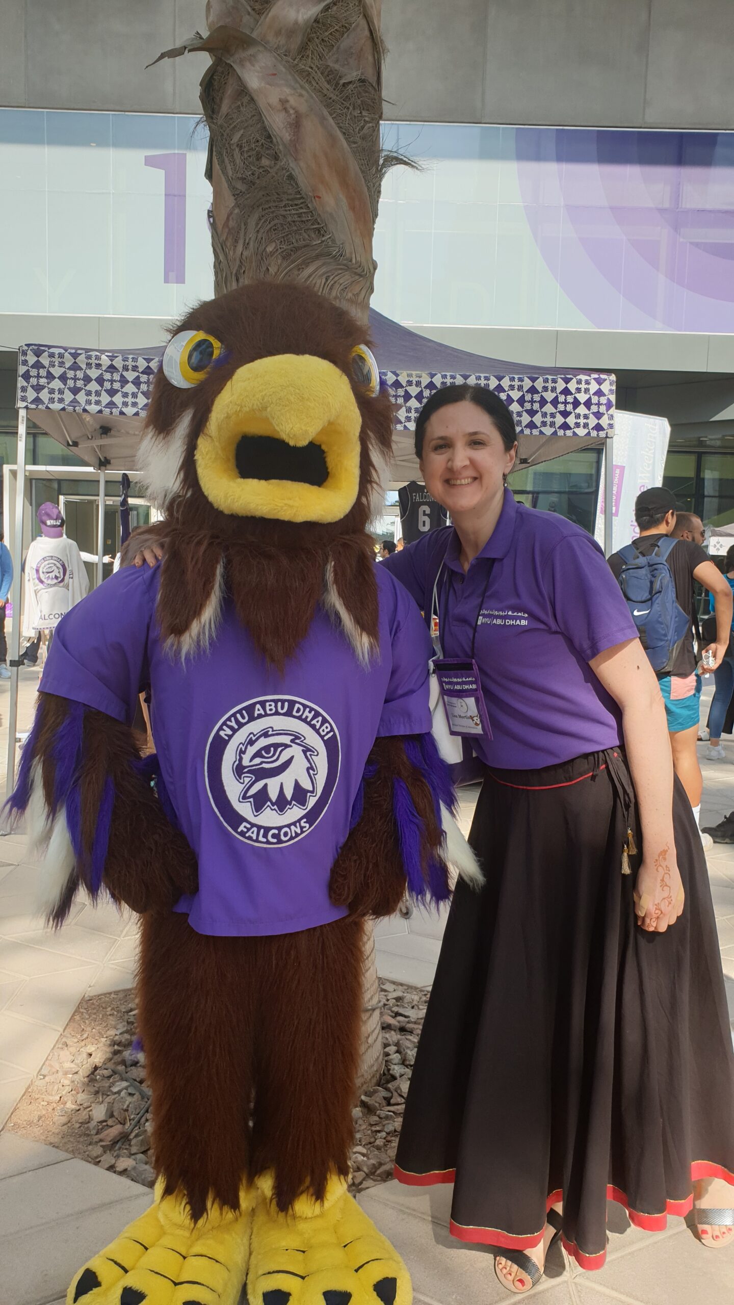 NYU Abu Dhabi’s mascot, Faiza the Falcon, and the author.