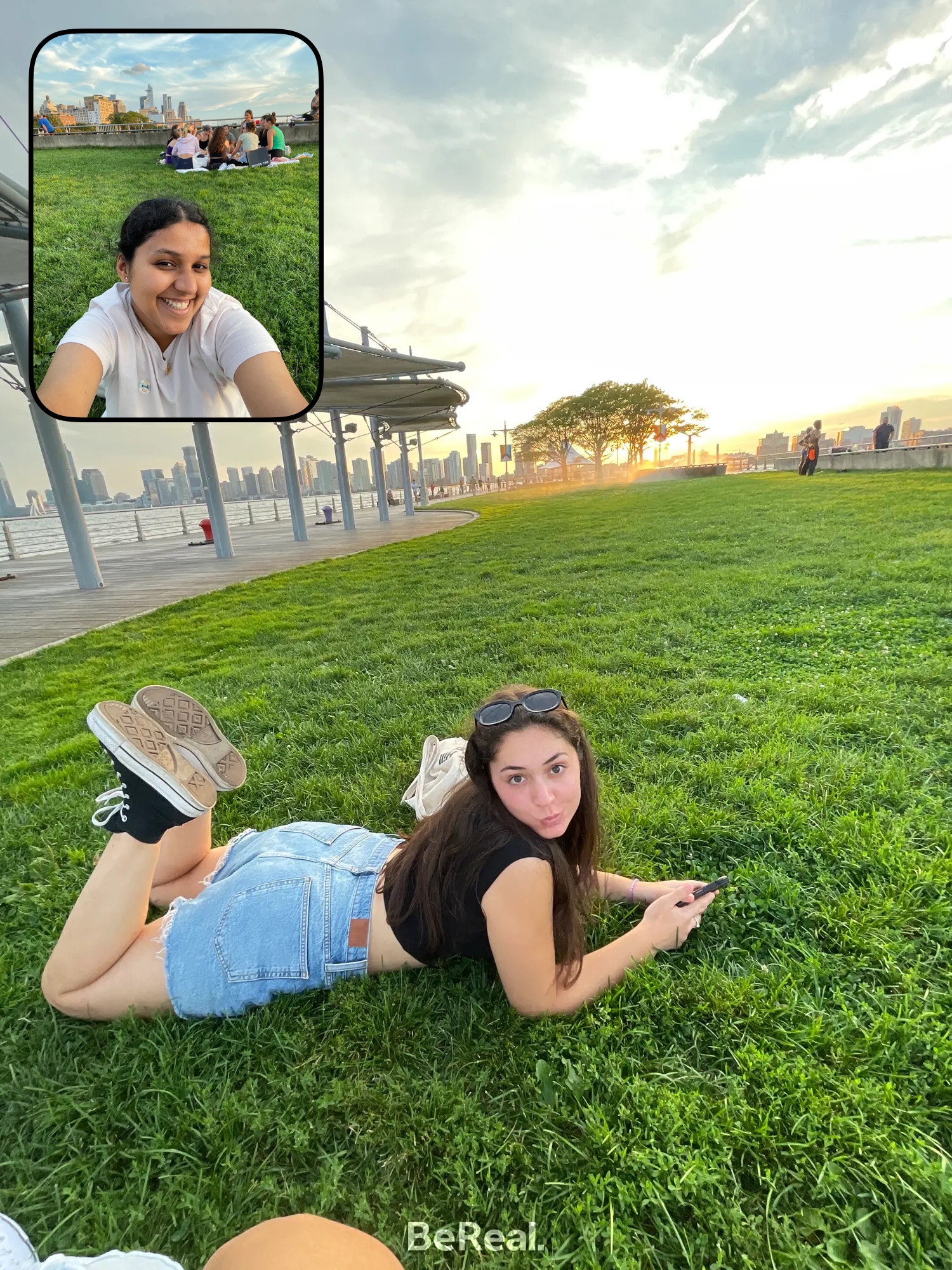 Anjana and her friend are on the grass at the piers