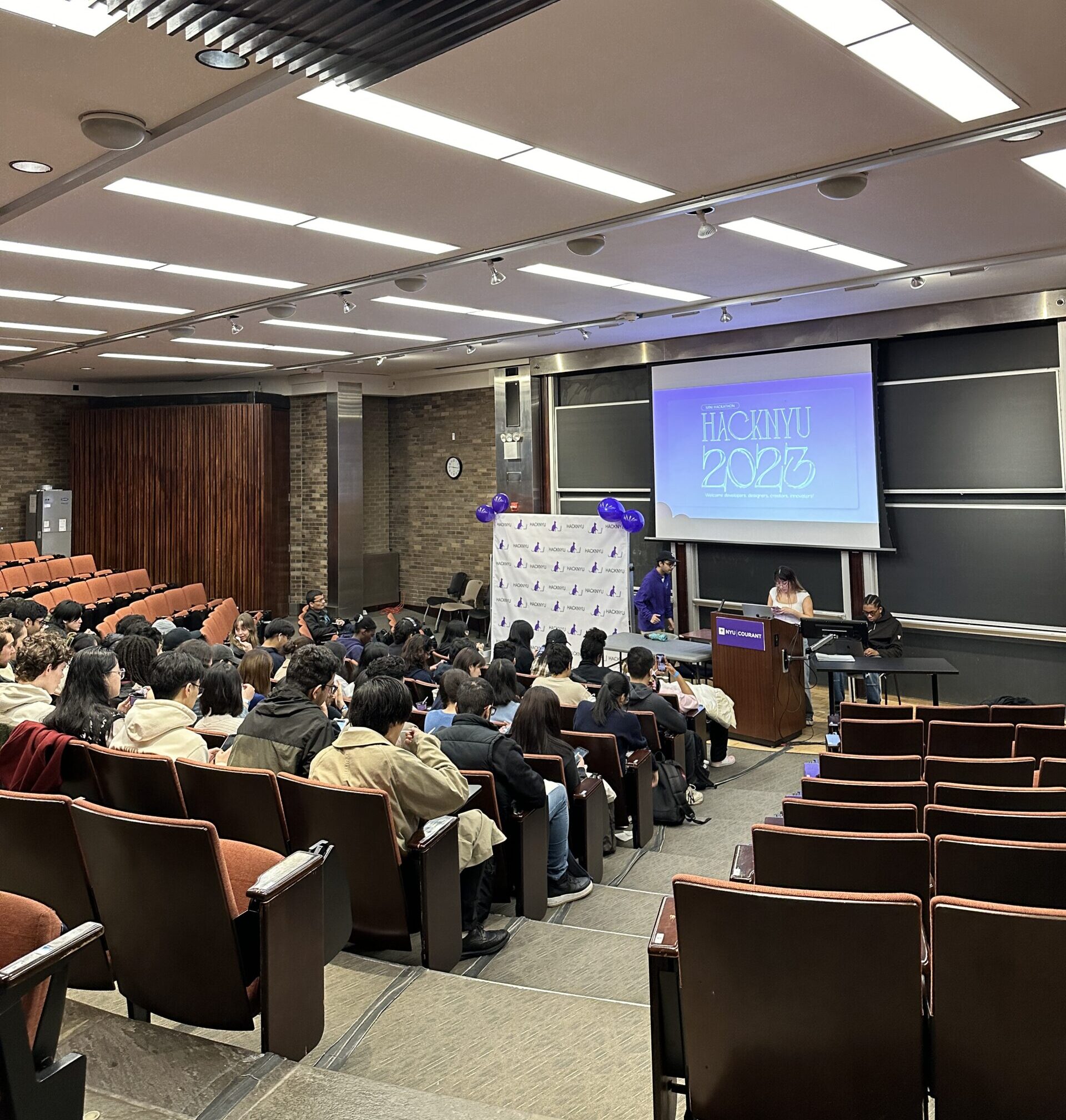 Students attending the 2023 Hackathon opening event in a lecture hall.
