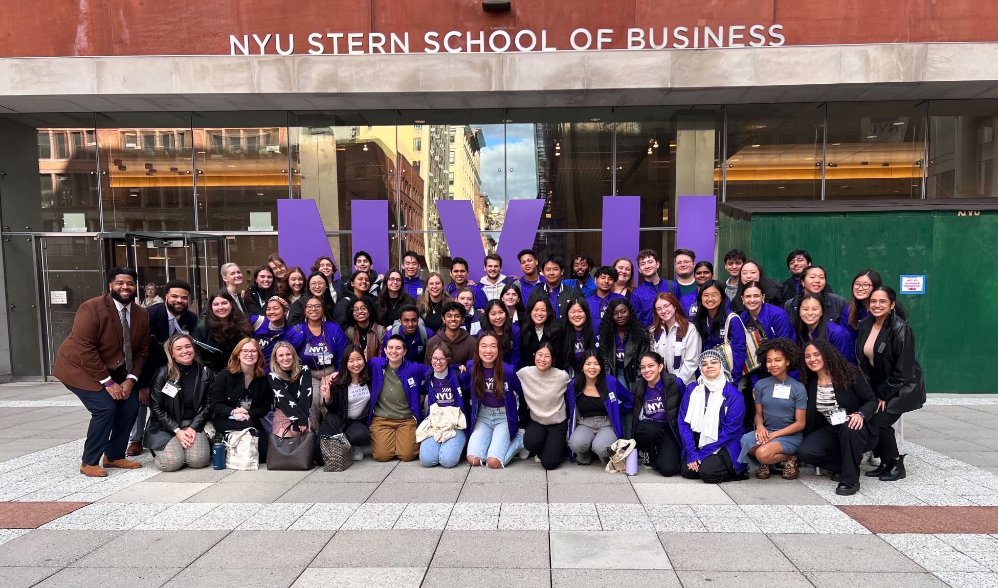 NYU Admissions Ambassadors pose together outside the NYU Stern School of Business. Being an Admissions Ambassador at NYU is an on-campus job.