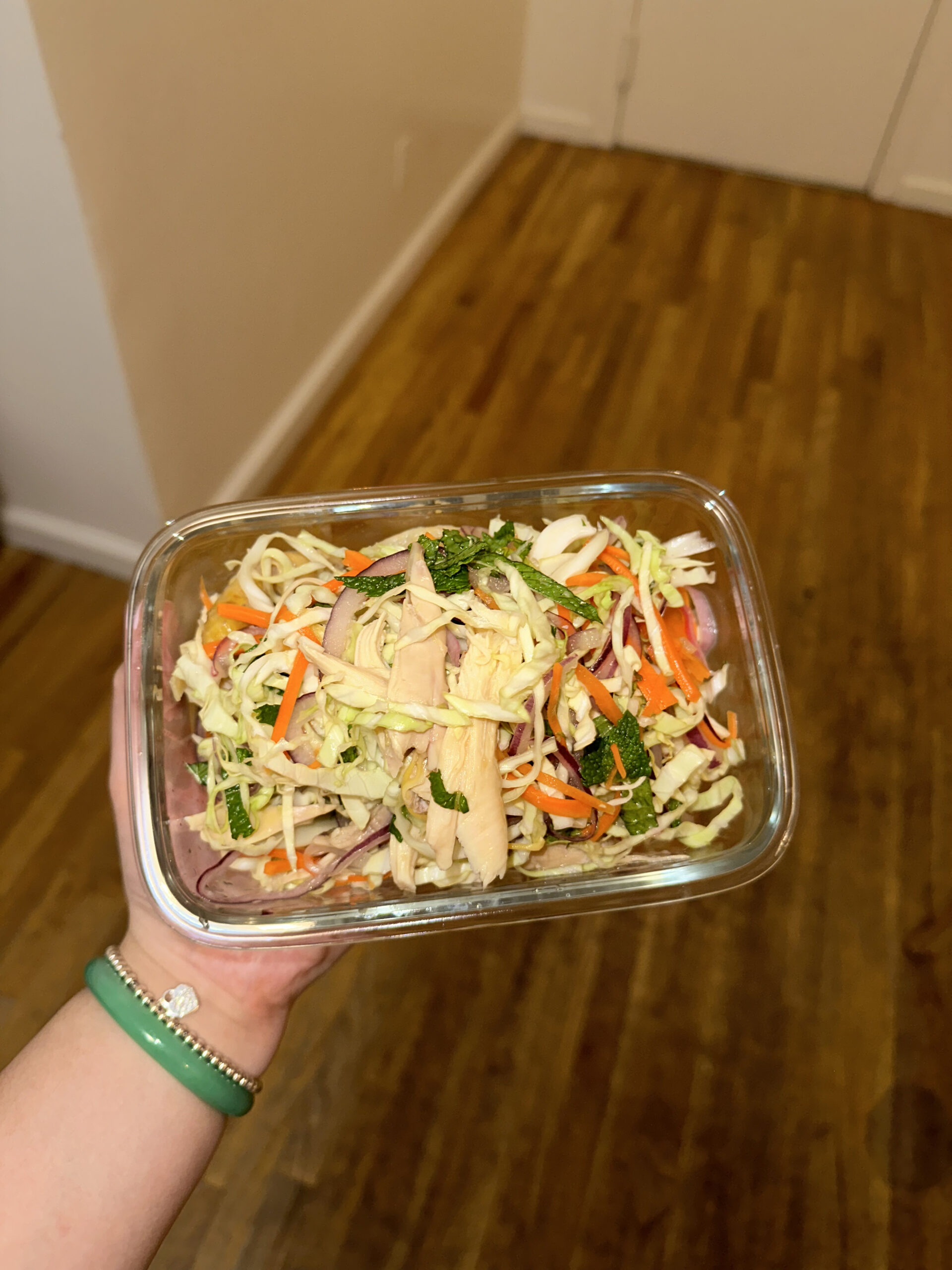 holding a bowl of vietnamese chicken salad
