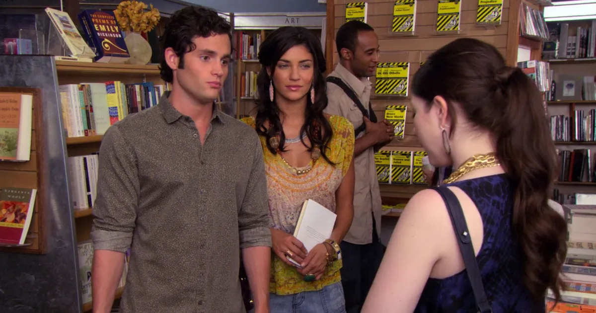 Vanessa and Dan stand next to each other in a bookstore as Georgina stands in front of them.