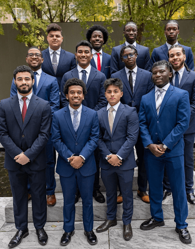 Students in suits standing for a group portrait.