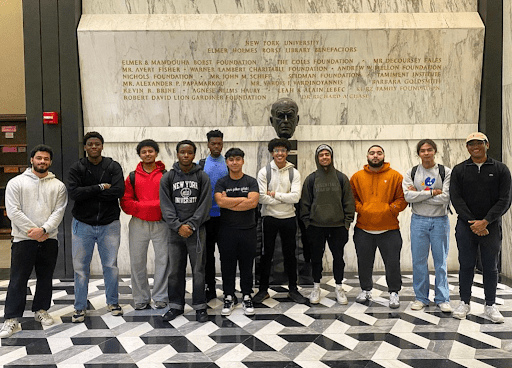 Students standing in front of a monument for a group photo.