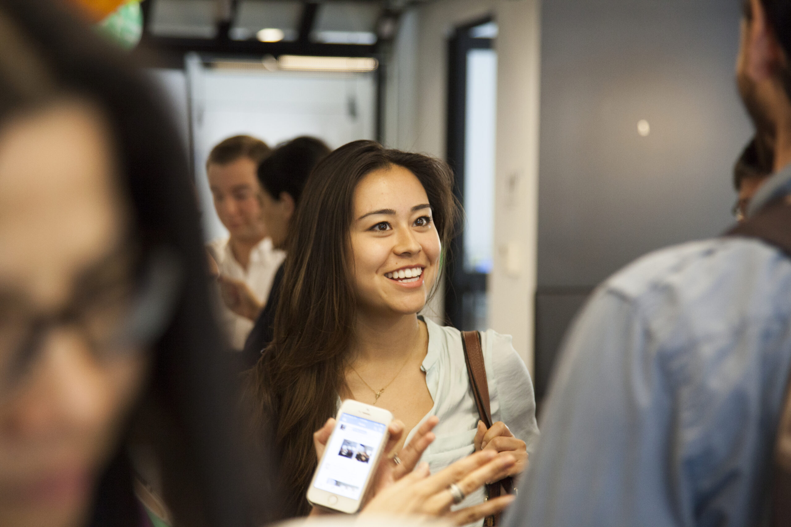 A student talking with others at a conference.