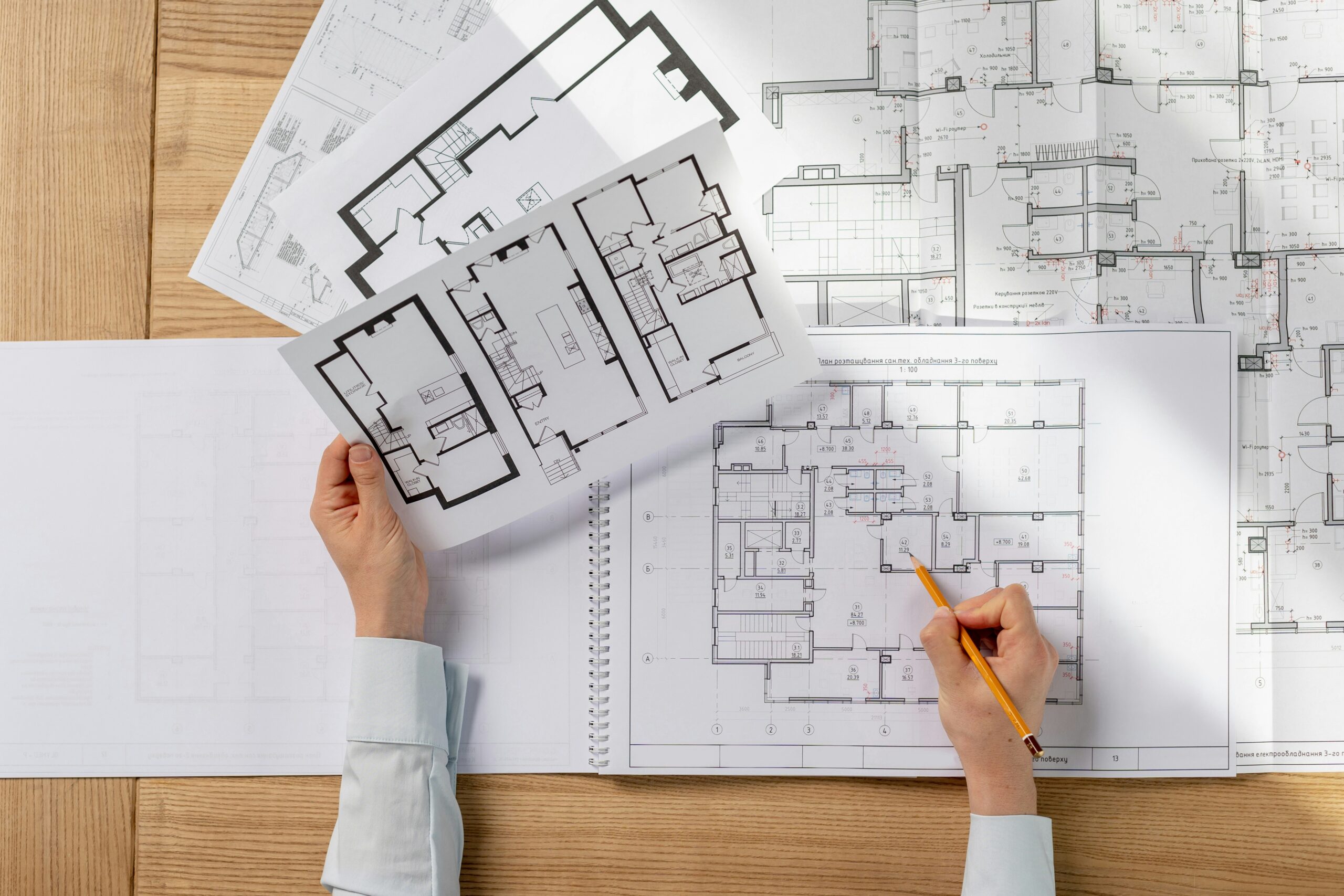 A person working on floor plans for a building.