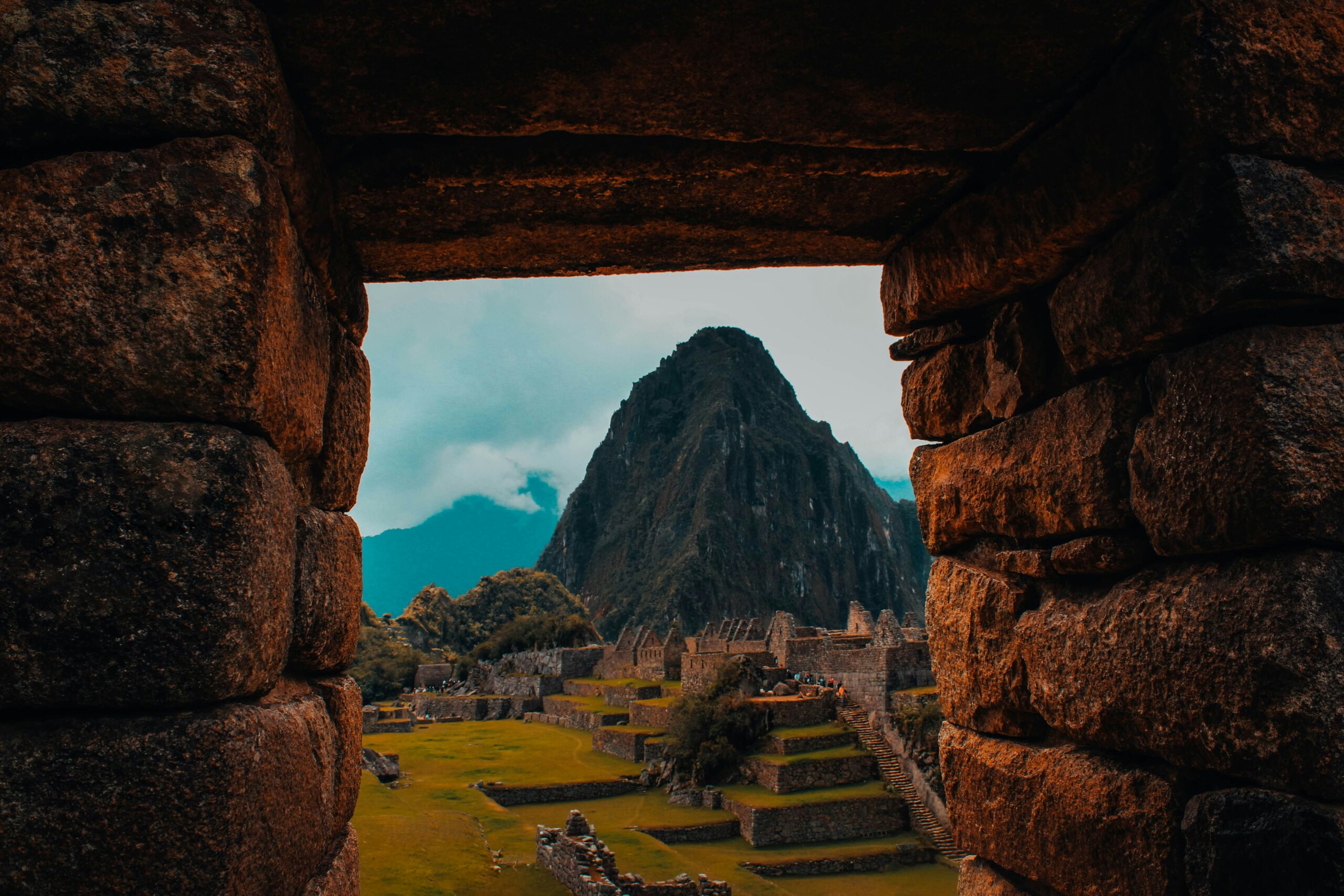 A mountain in Peru with ruins next to it.