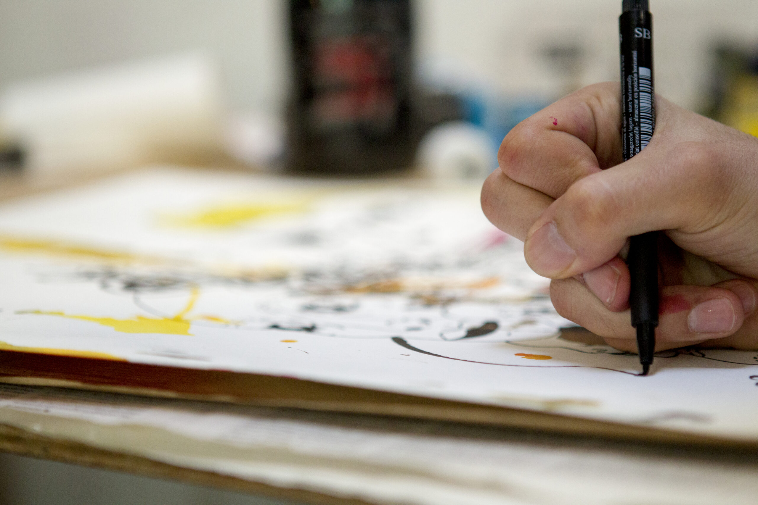 A student sketching on paper.