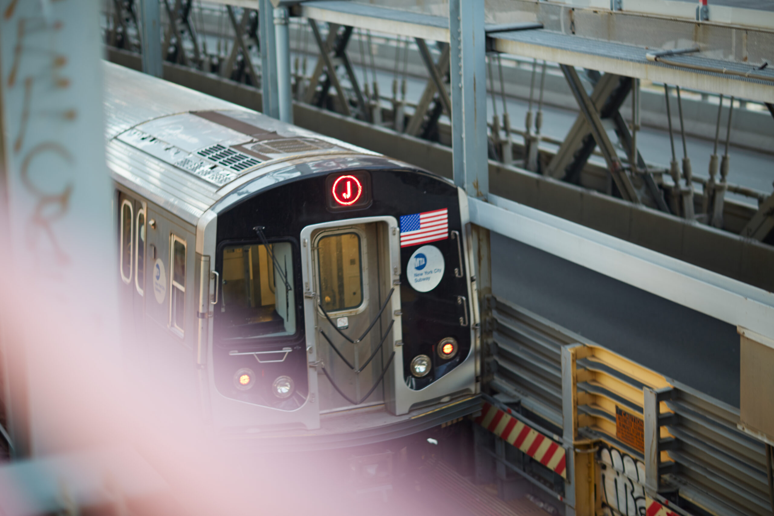 A subway car in motion on the tracks.