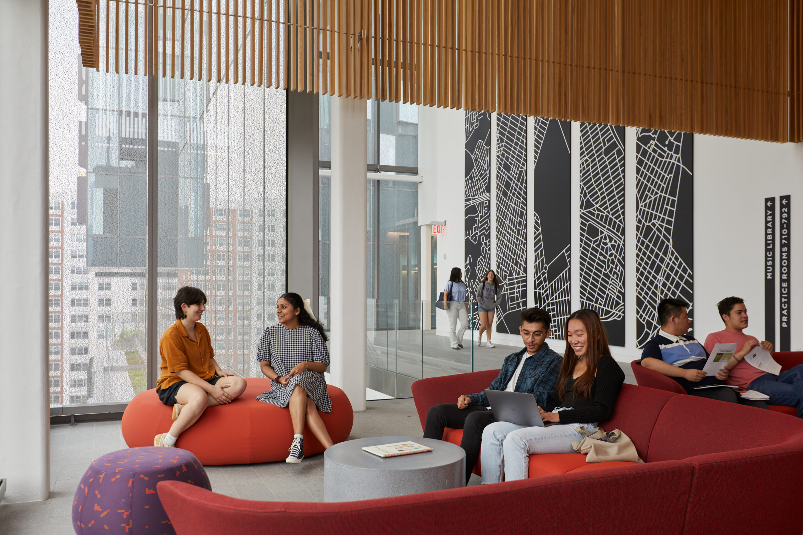 Students socializing in a lounge area within the Paulson Center on the New York City campus.