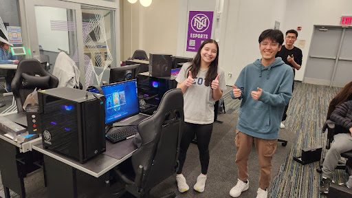 Students hanging out in the new gaming space at Third North Residence Hall. They are all giving a thumbs-up.