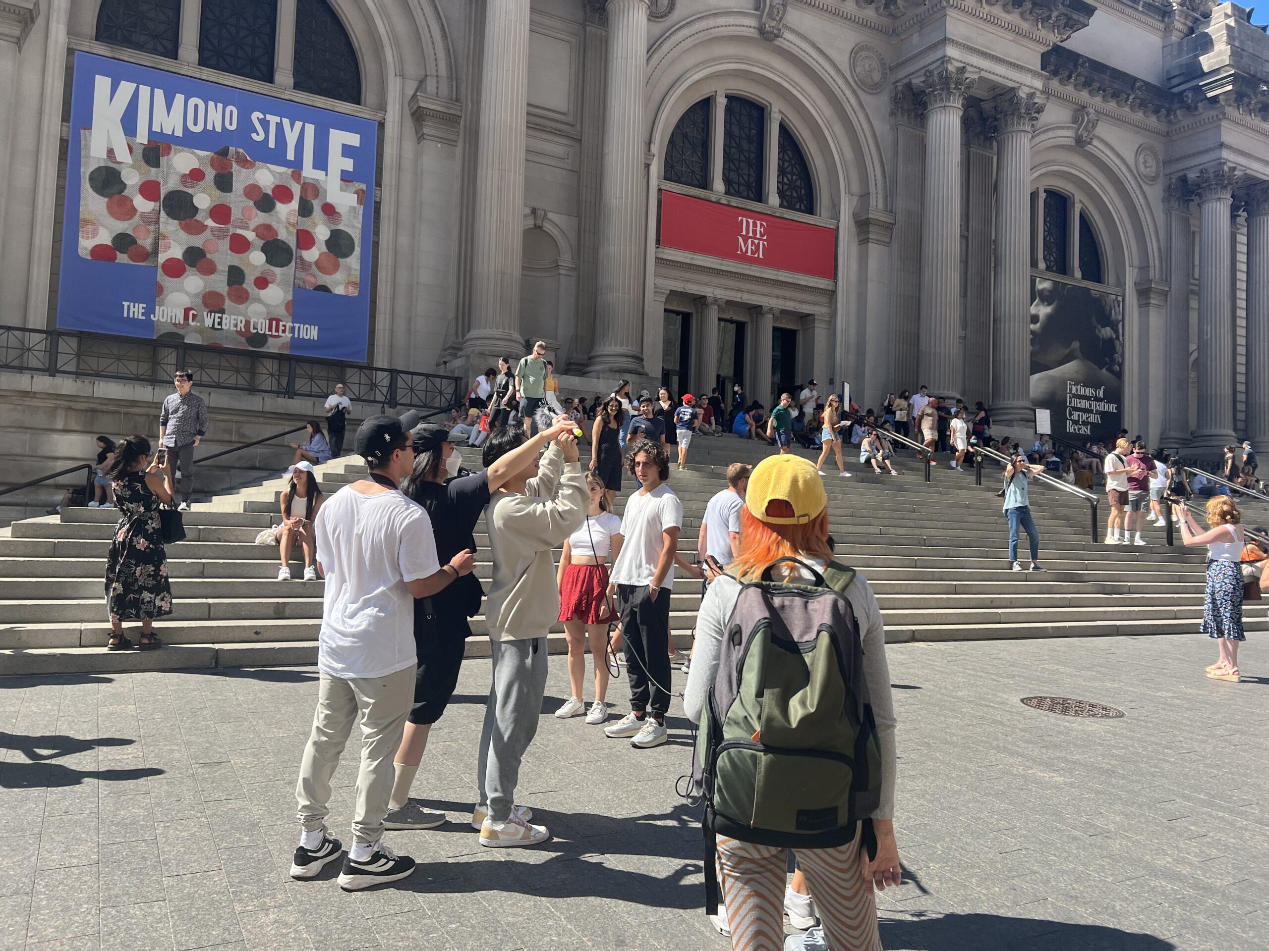 Behind the scenes of the Sight and Sound: Filmmaking production course. A group of students film a project outside of The Metropolitan Museum of Art.