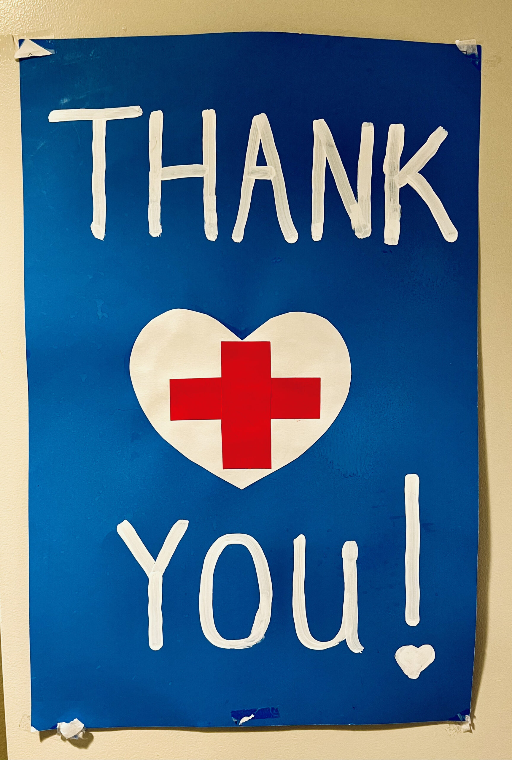 A blue, white, and red “Thank You!” poster for all health-care workers.