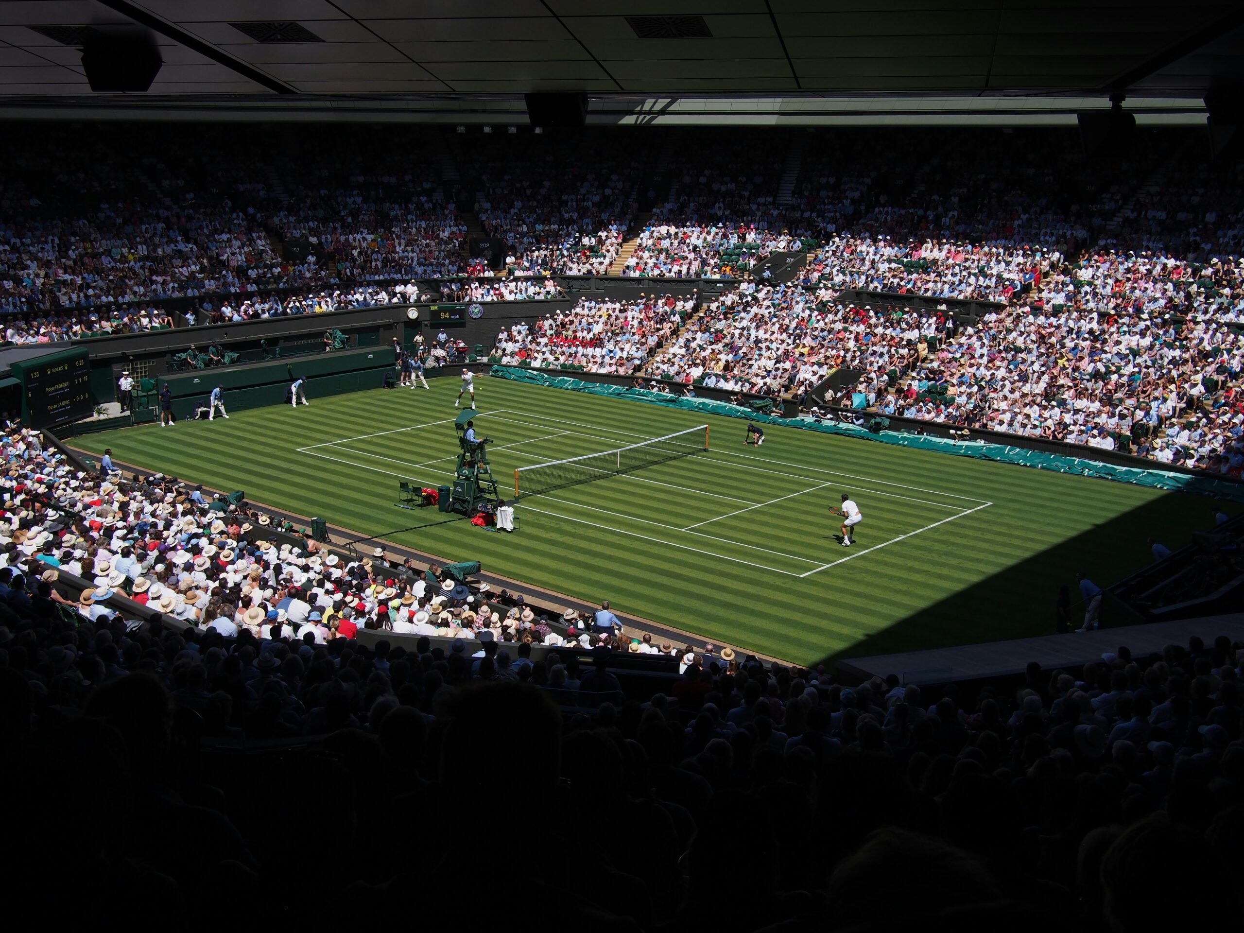 A spectator view of a professional tennis match in progress.