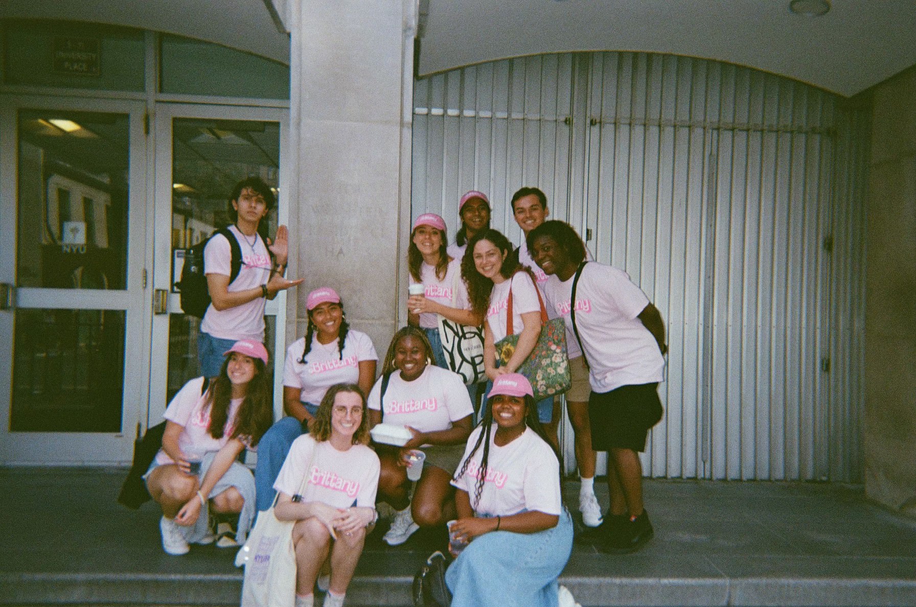 A group of resident assistants posing outside of a residence hall.