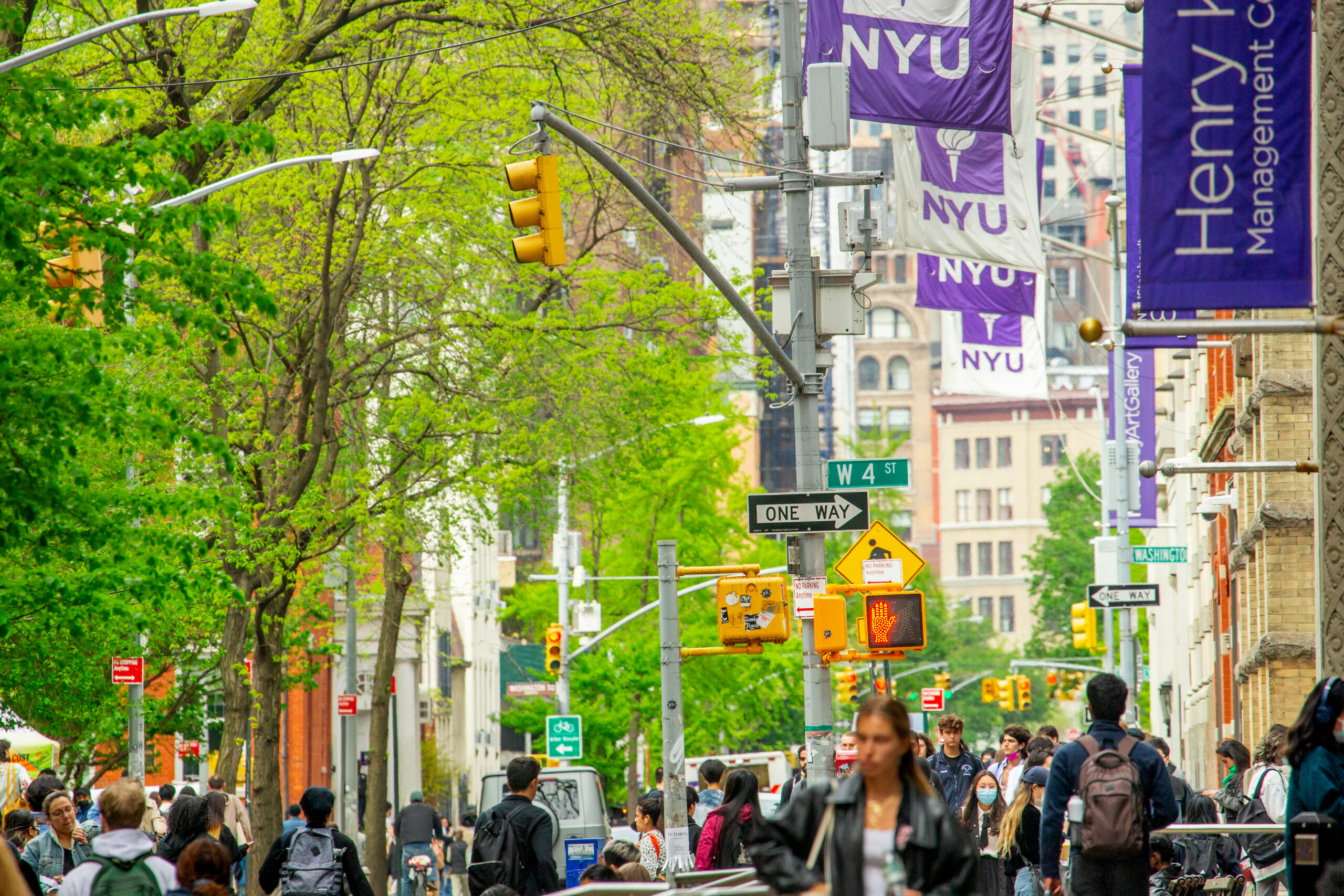 A street busy with pedestrians on the NYU campus.