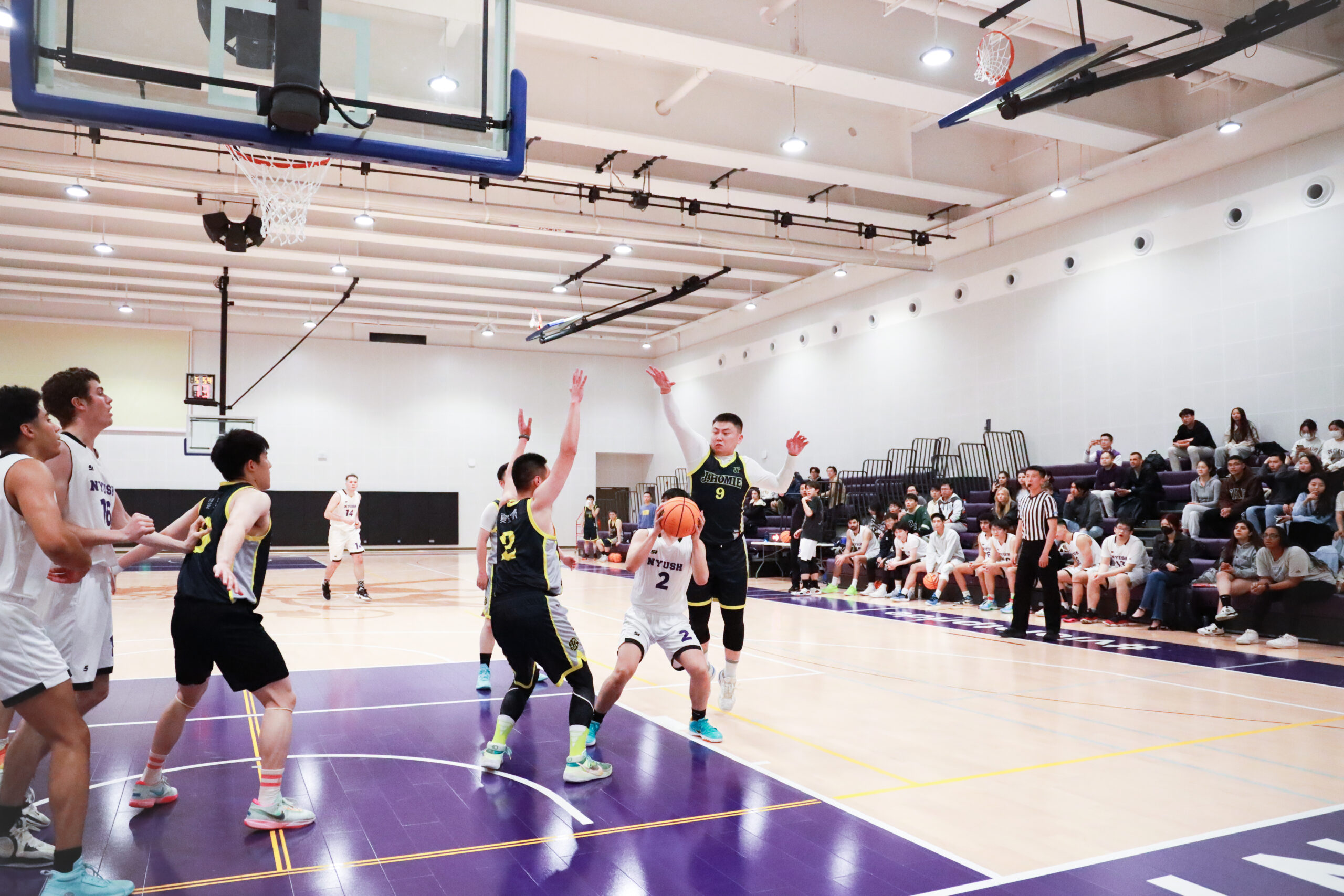 The NYU student team play basket ball in the student athletic center