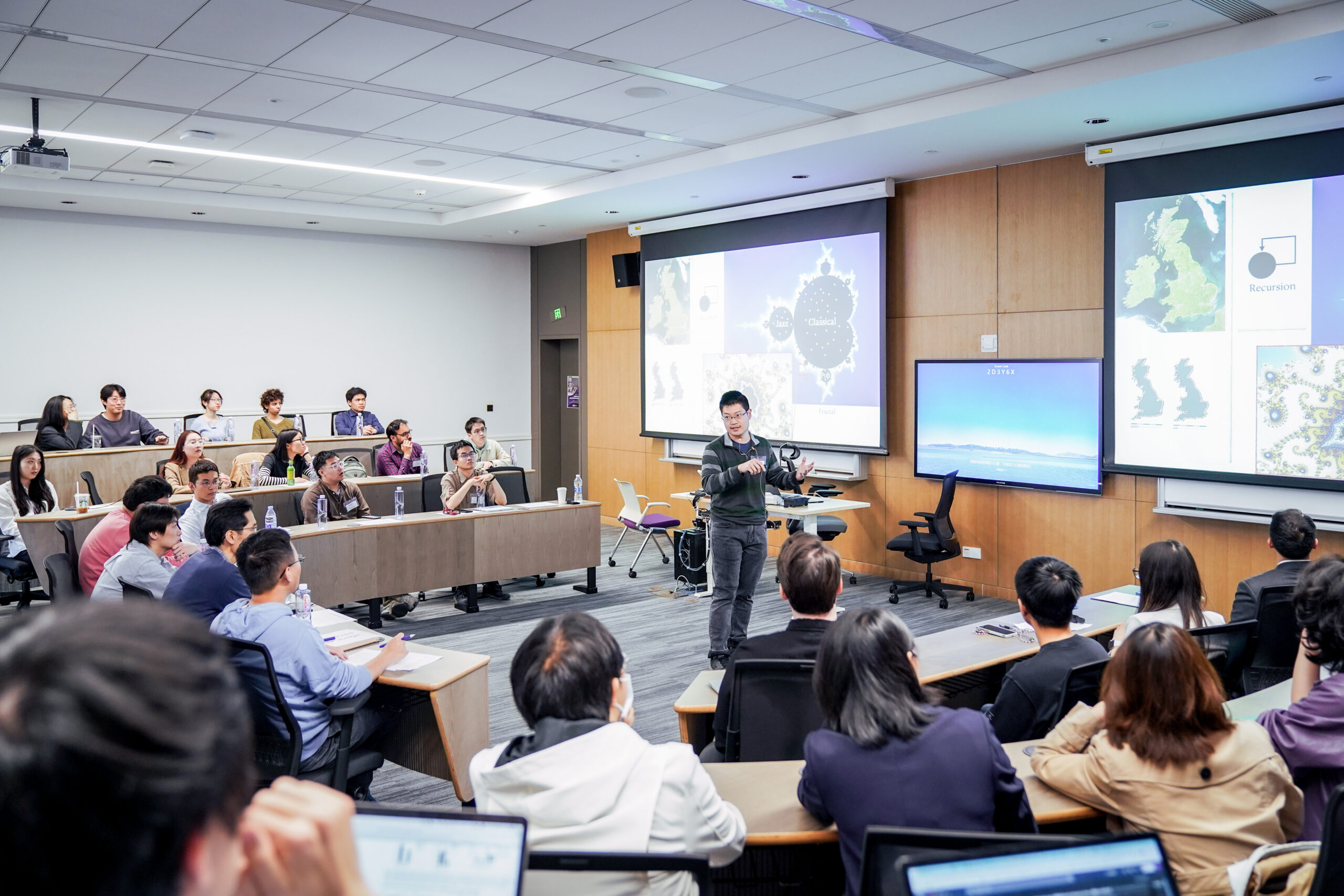 Students sit in a seminar style classroom at NYUSH