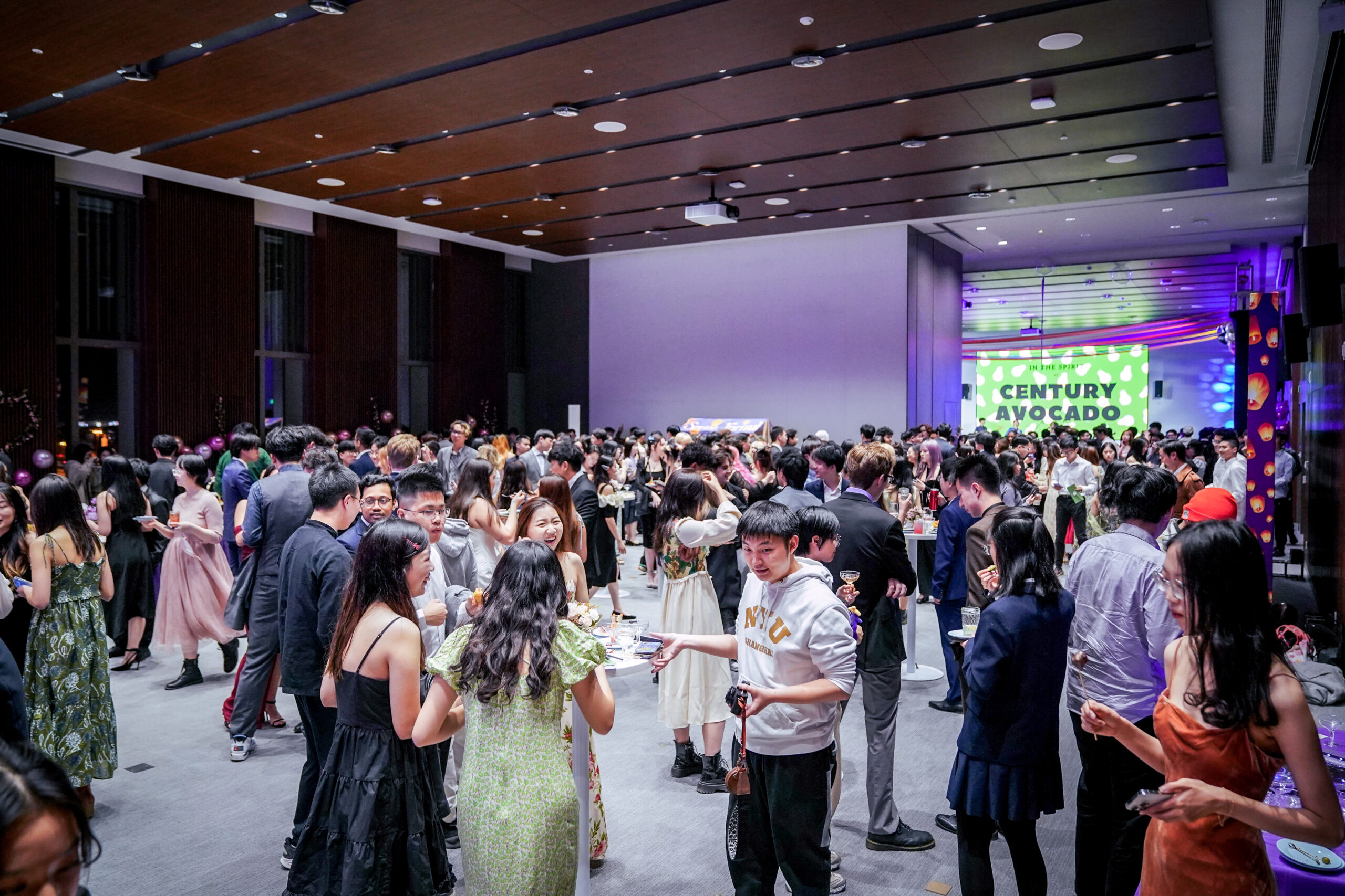 Dozens of students mingling during an event at the colloquium