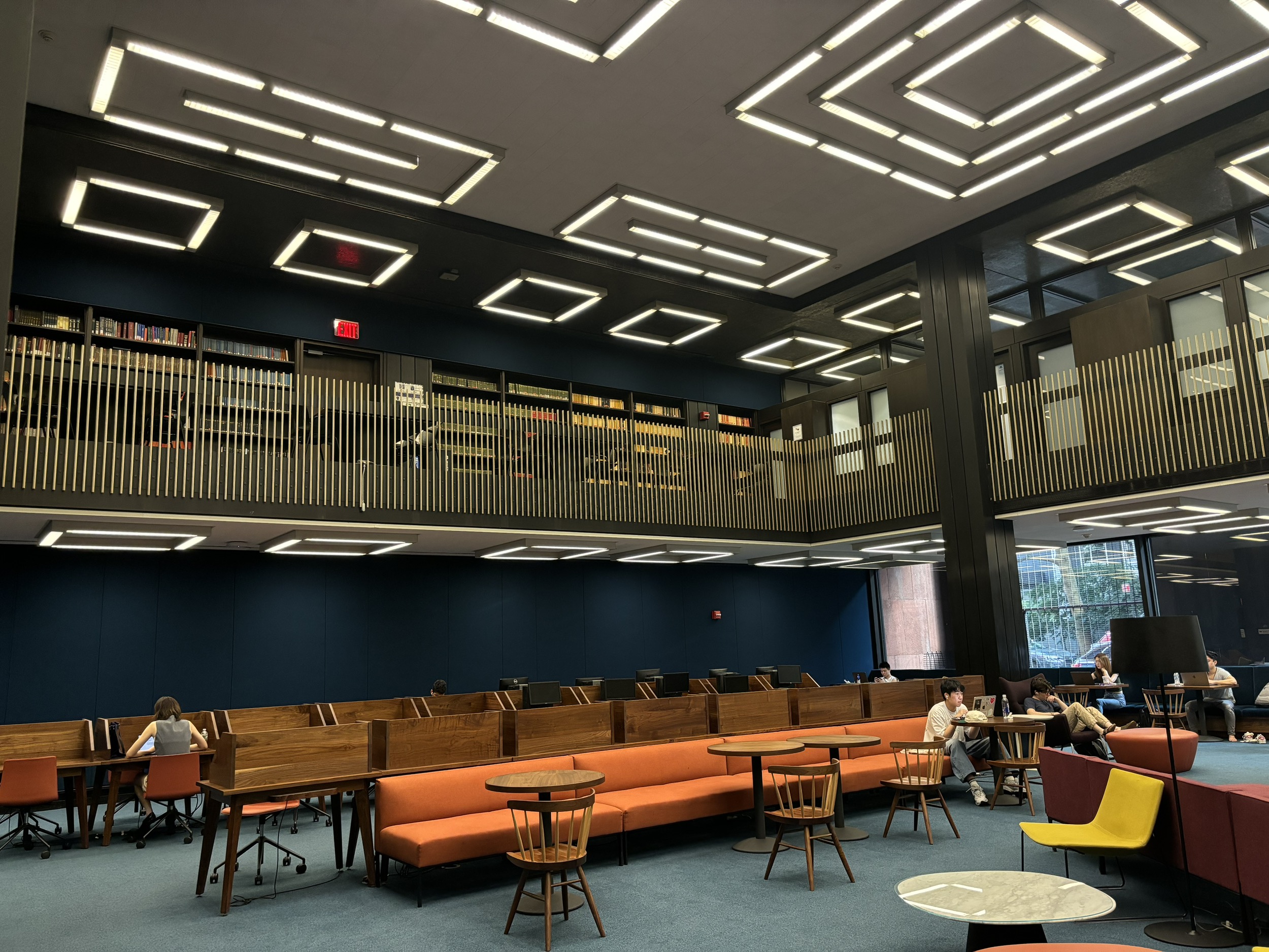 The Bobst Library Reference Center with ground floor seating and an indoor balcony area.