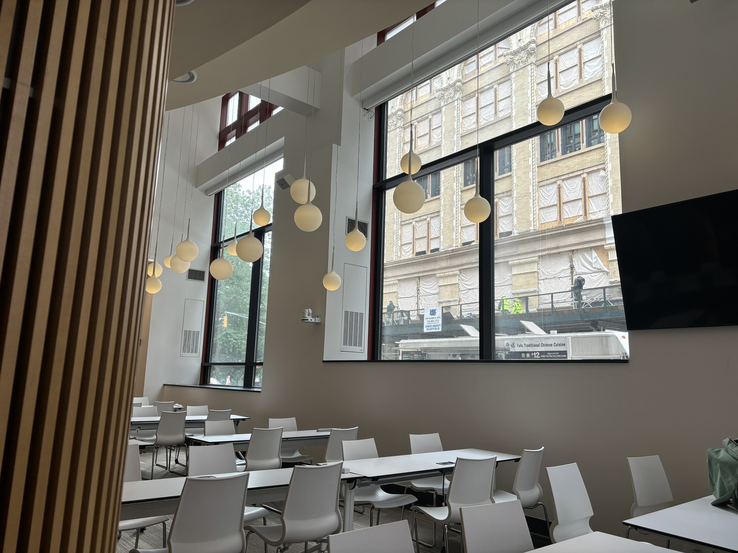 The Sosnoff Lounge, vacant, with rows of desks on the floor and lanterns hanging from the ceiling