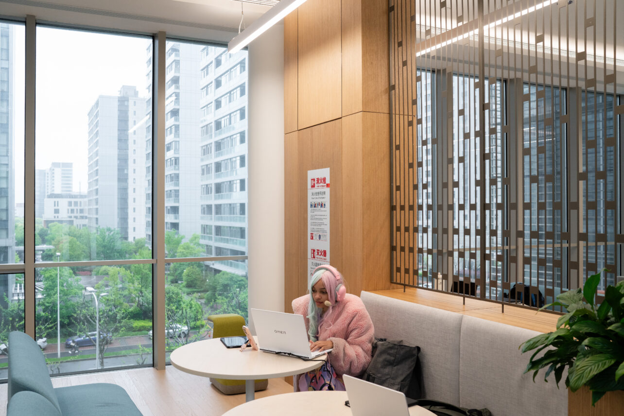 A student sits in the John E. Sexton Sky Bridge