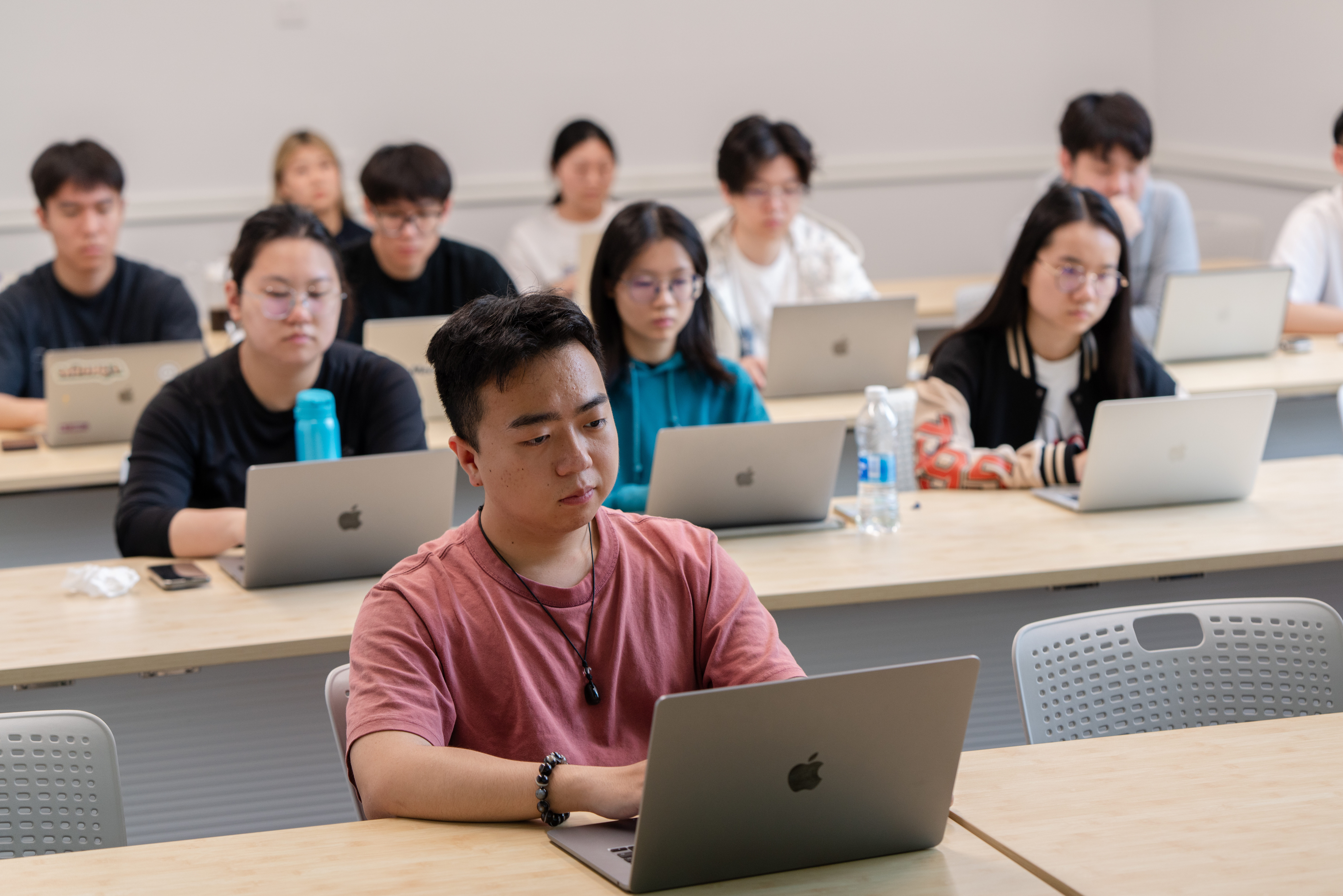 NYUSH students sit in a lecture-style classroom