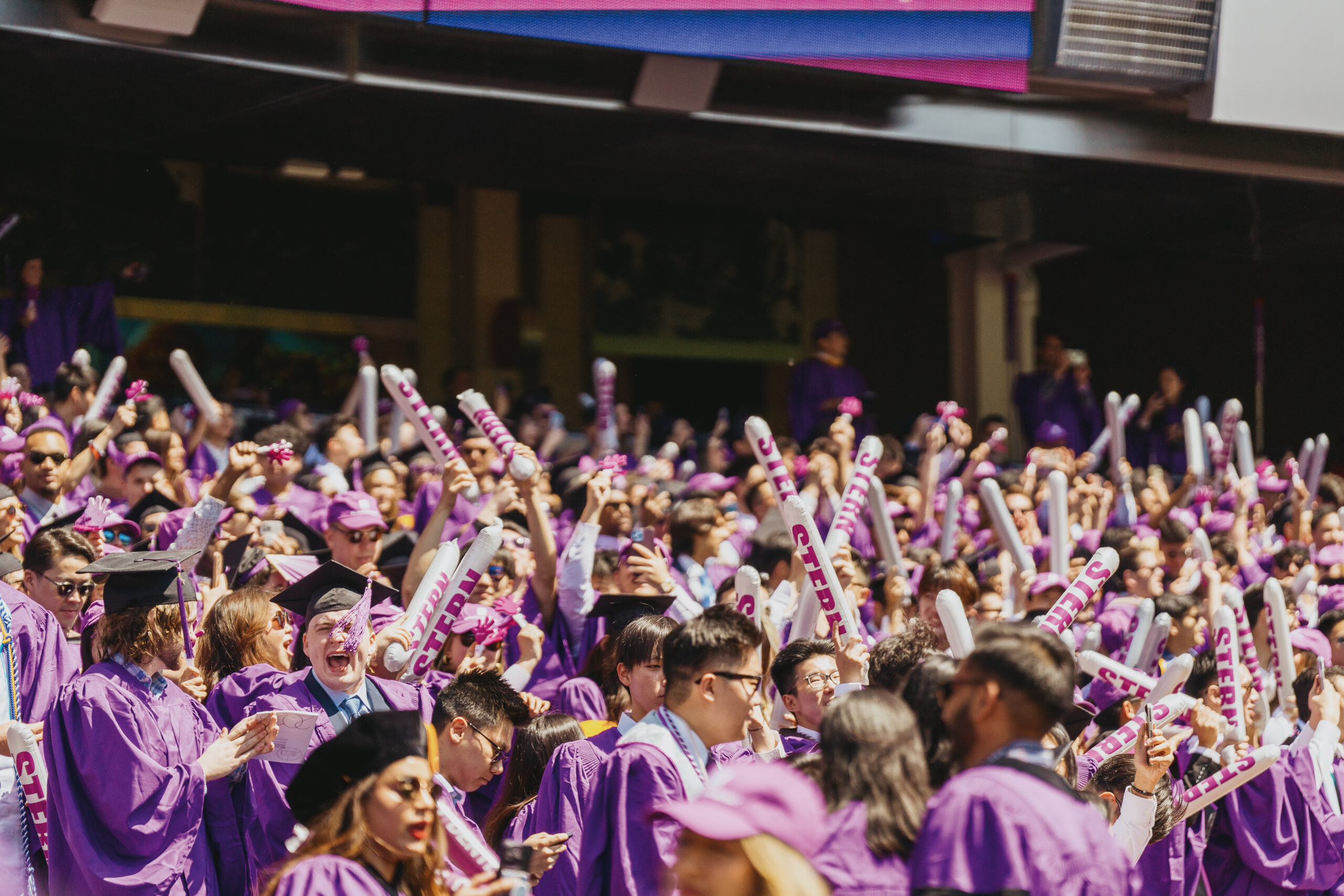 A large group of students celebrating at NYU’s Commencement.