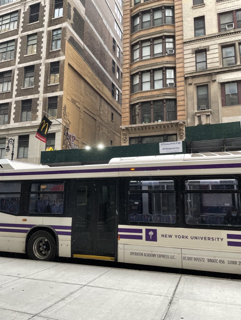 An NYU Shuttle stopped outside of the Tisch building in Manhattan.