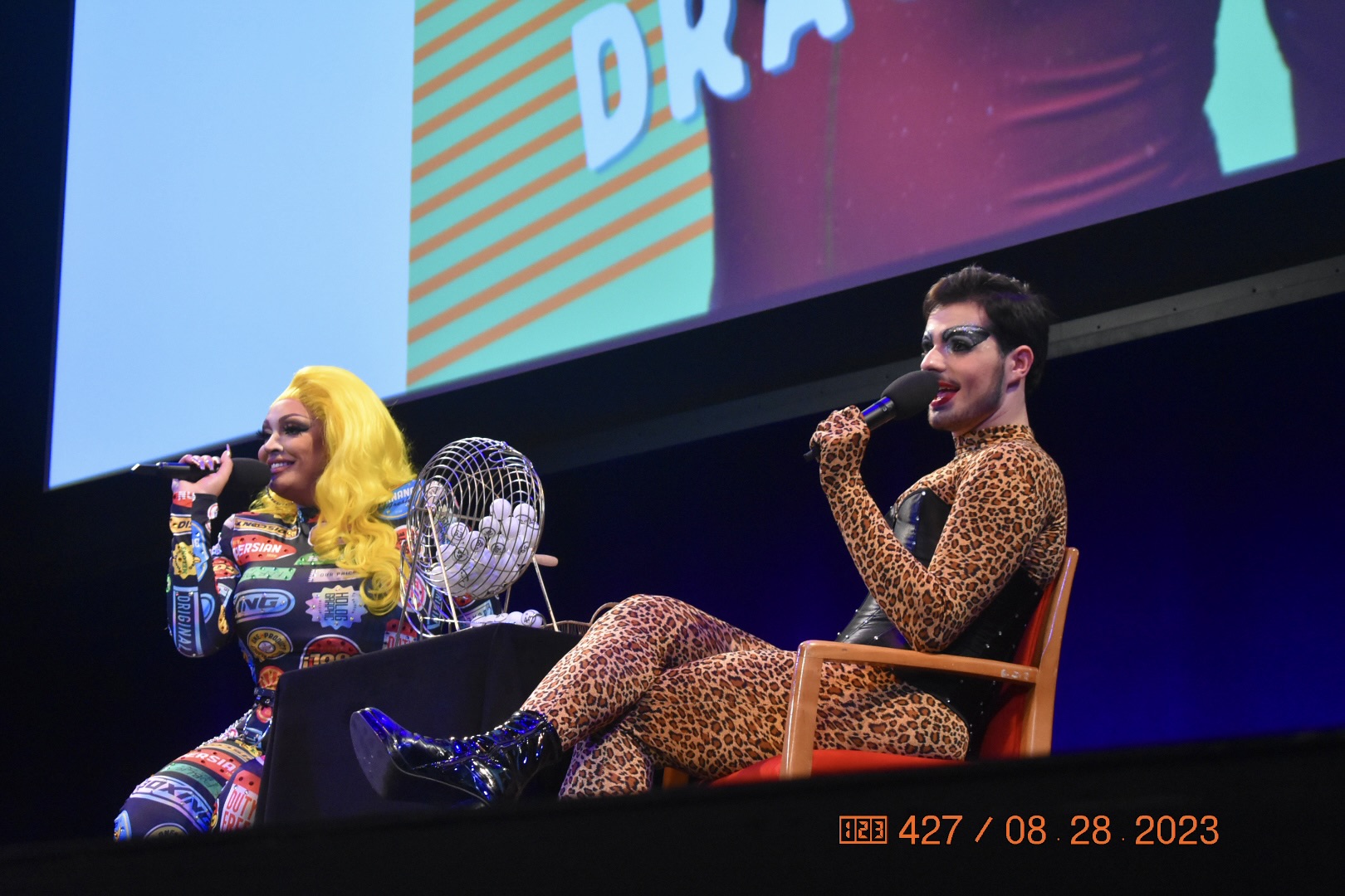 NYU student Toby onstage as Toast cohosting NYU’s Drag Bingo with another drag performer.