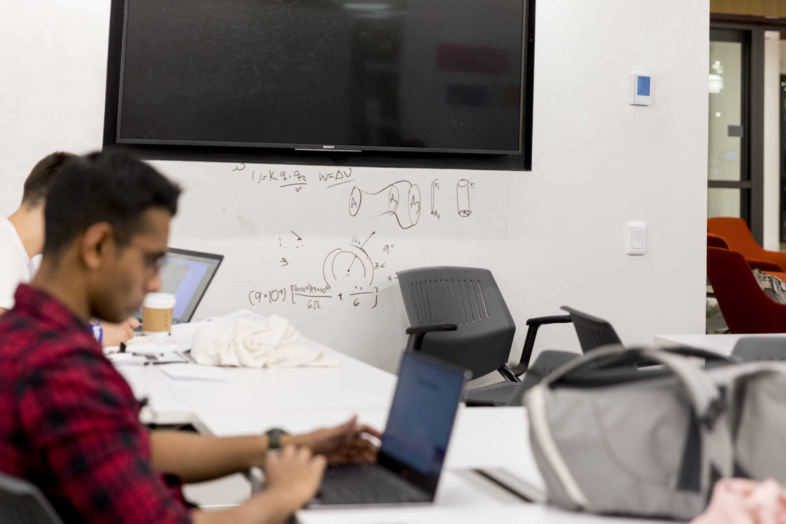 Two students working on their laptops.