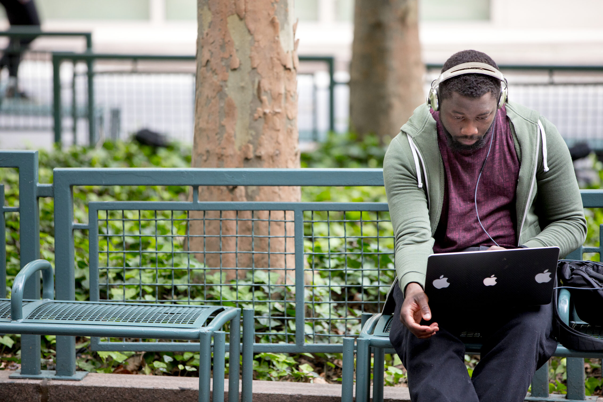 Student working on a park bench.