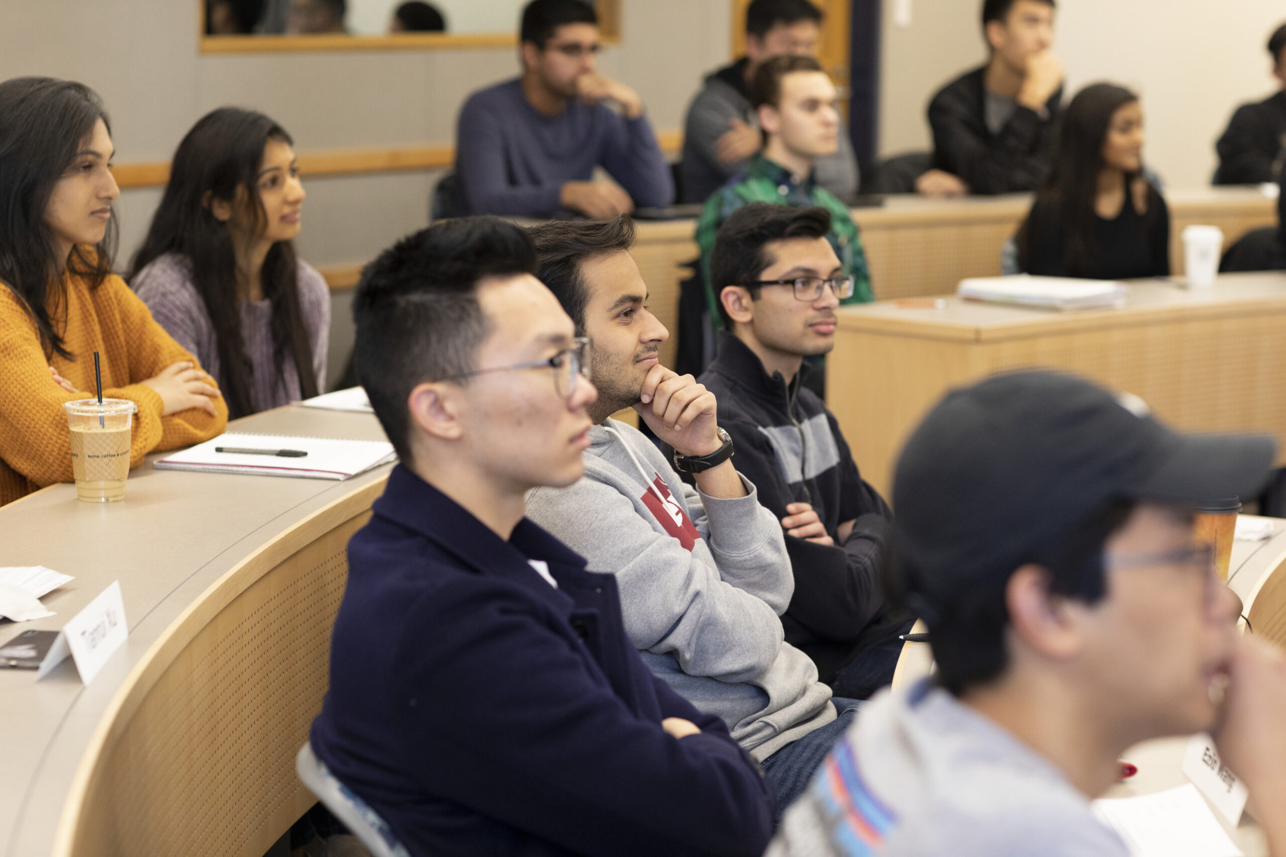 Students are seated and listening to a lecture.