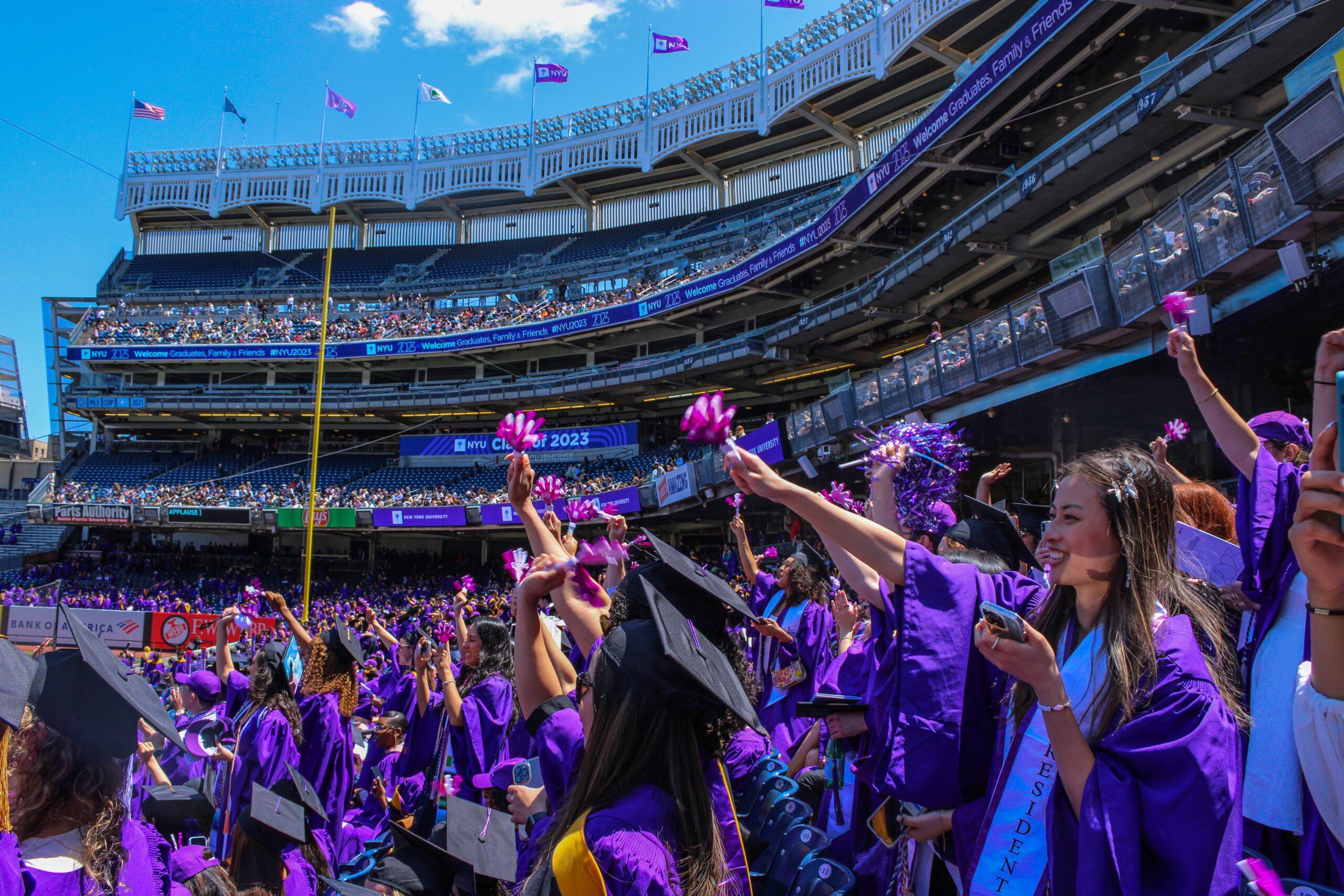 A large group of students celebrating at NYU’s Commencement.