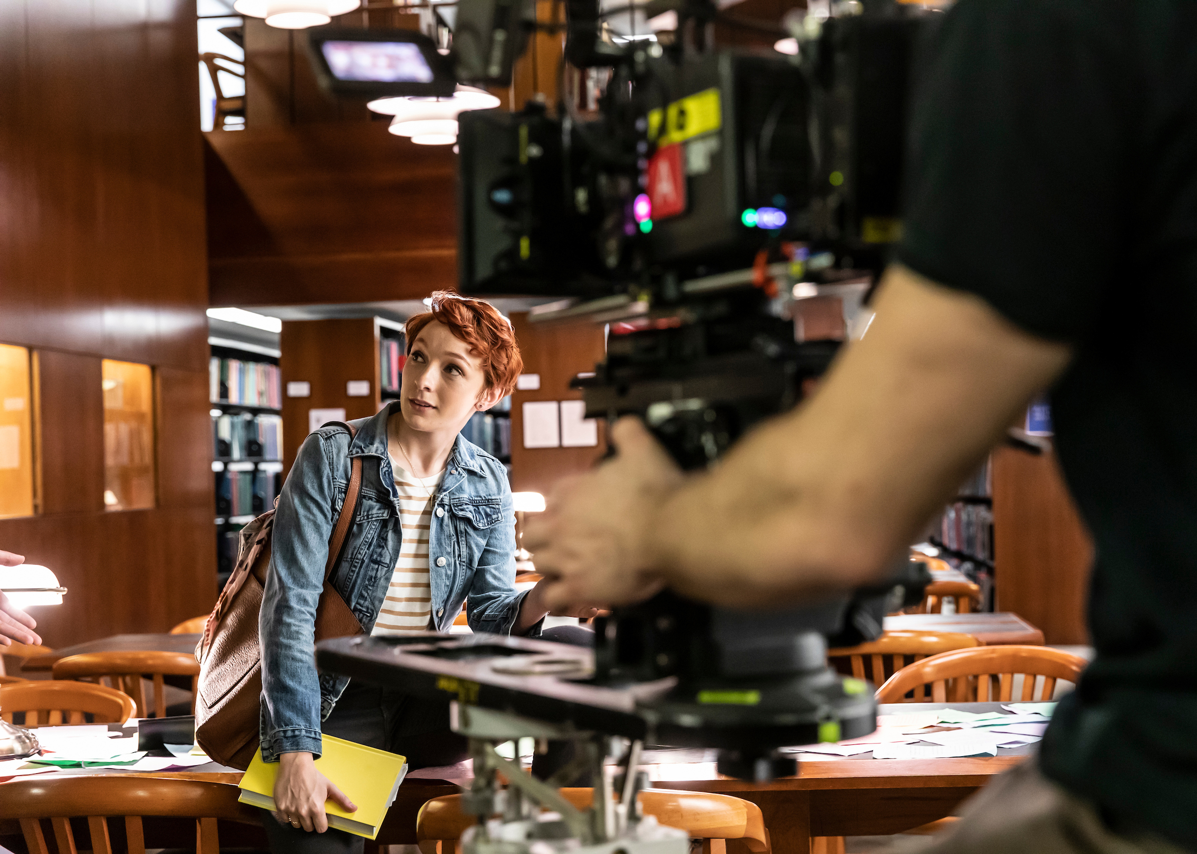 Arianna Gayle Stucki filming a scene in a library for a movie