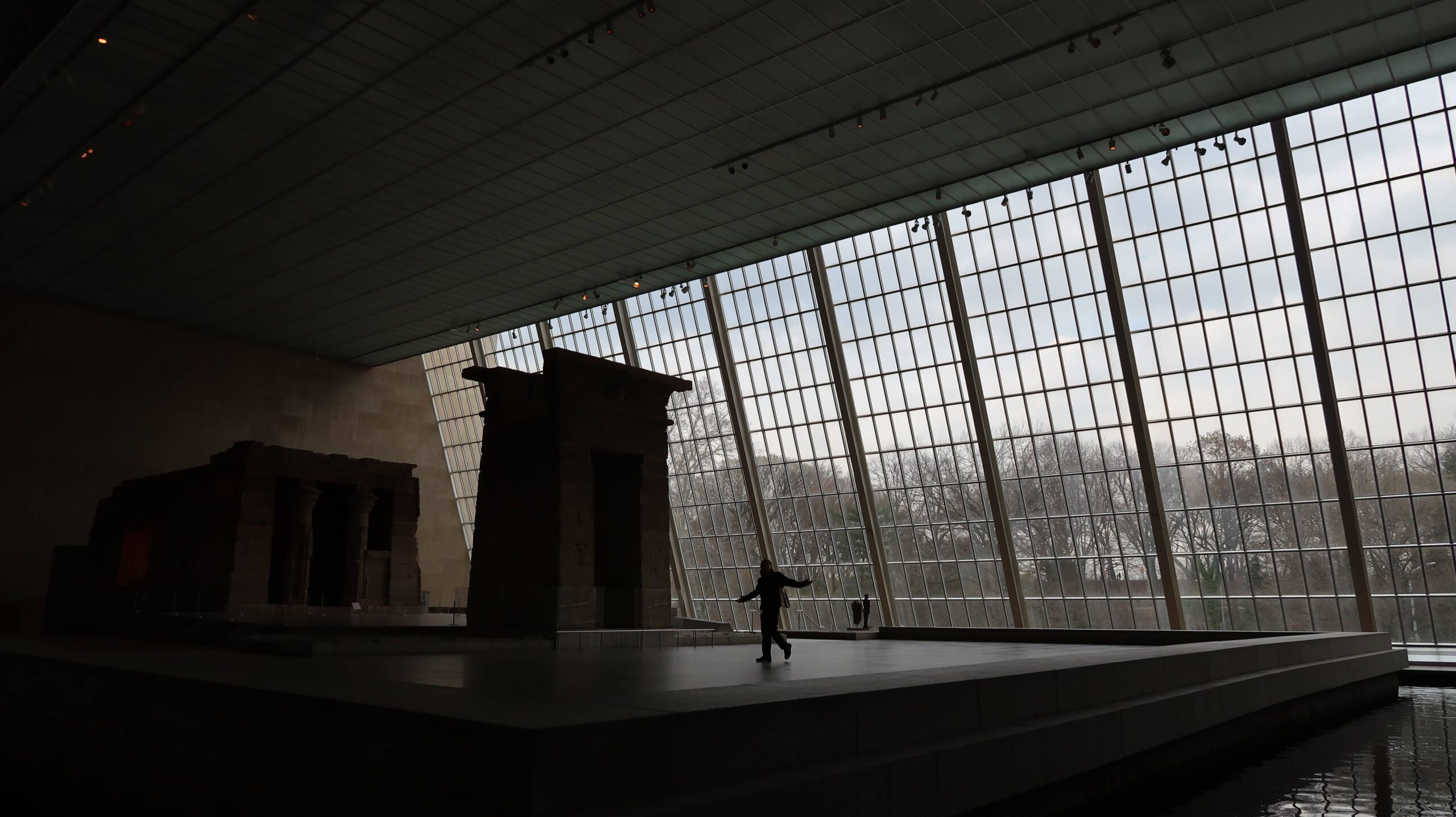 man walking through museum exhibit