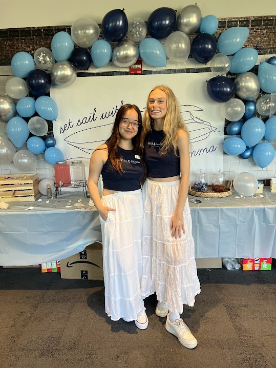 Two girls posing in matching outfits.