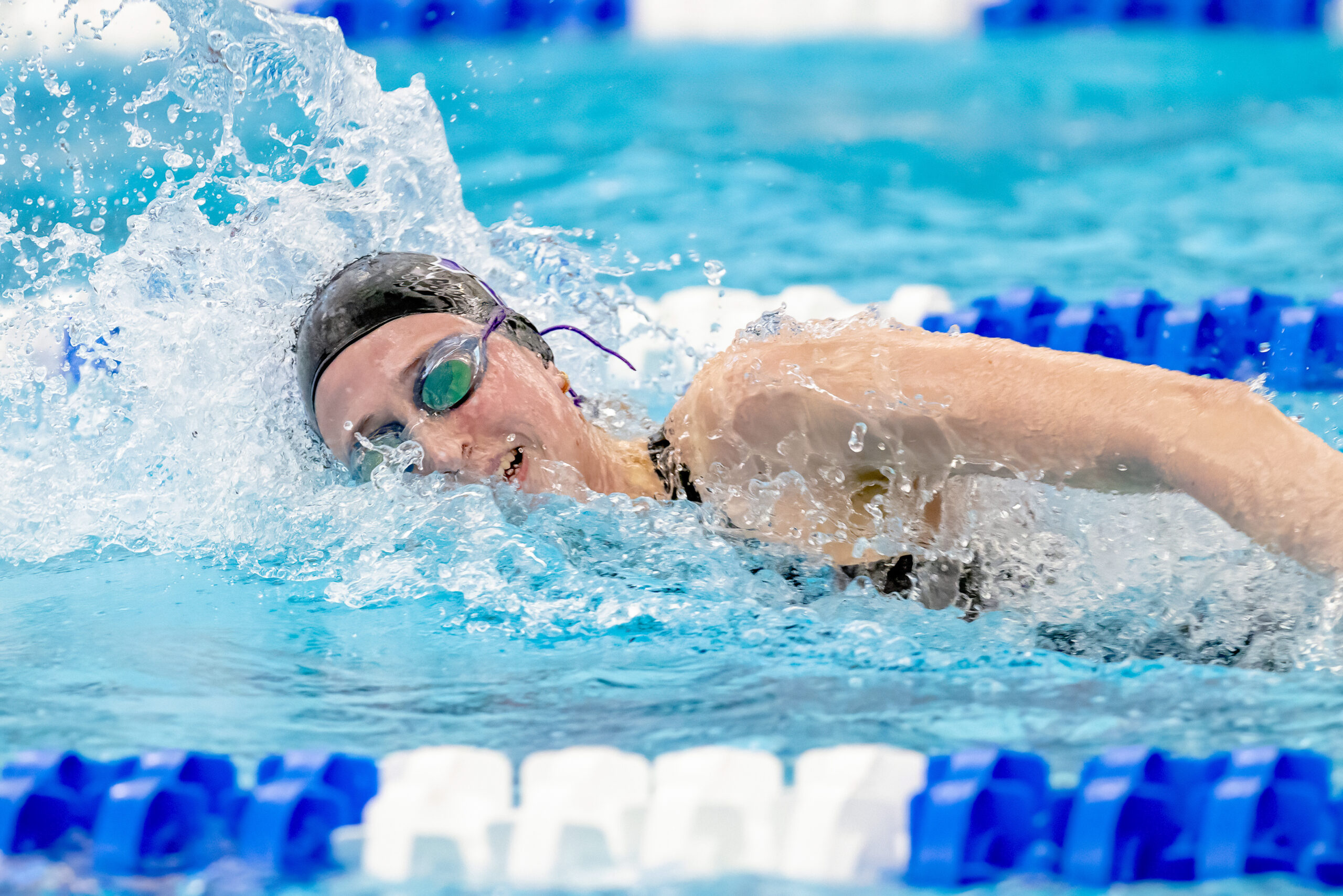 Kaley McIntyre, a student athlete, swimming in a competitive swim meet.