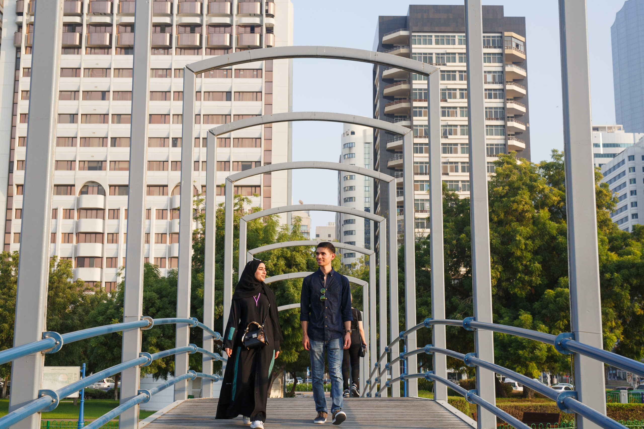 Student walking across a bridge in Abu Dhabi