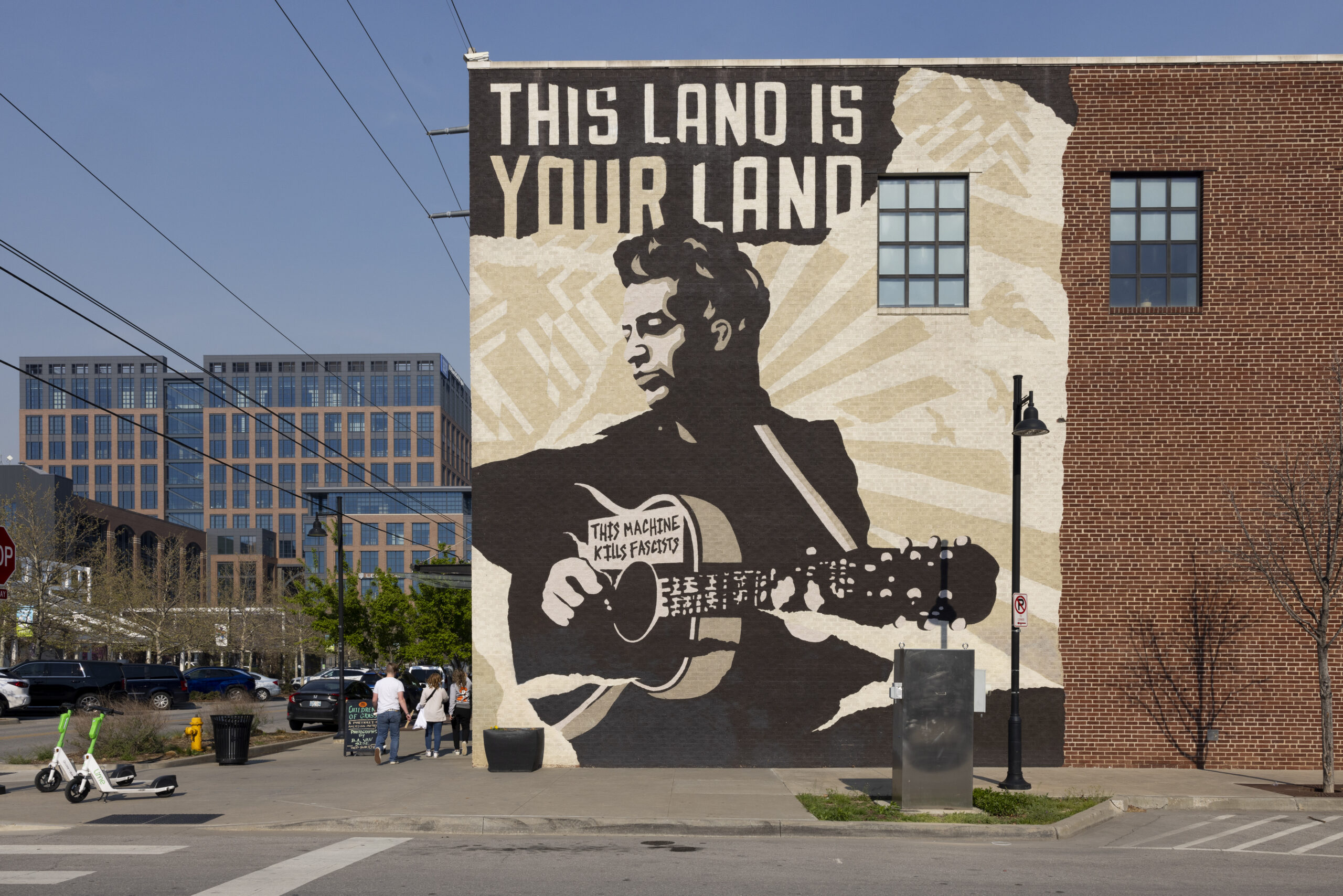 A mural of Woody Guthrie that reads 