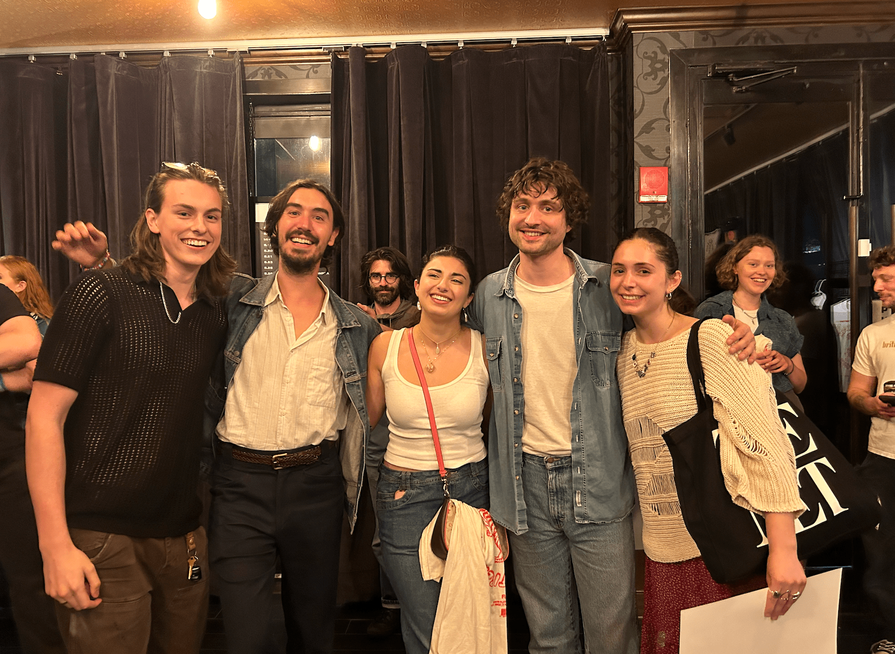 a group of five people smiling