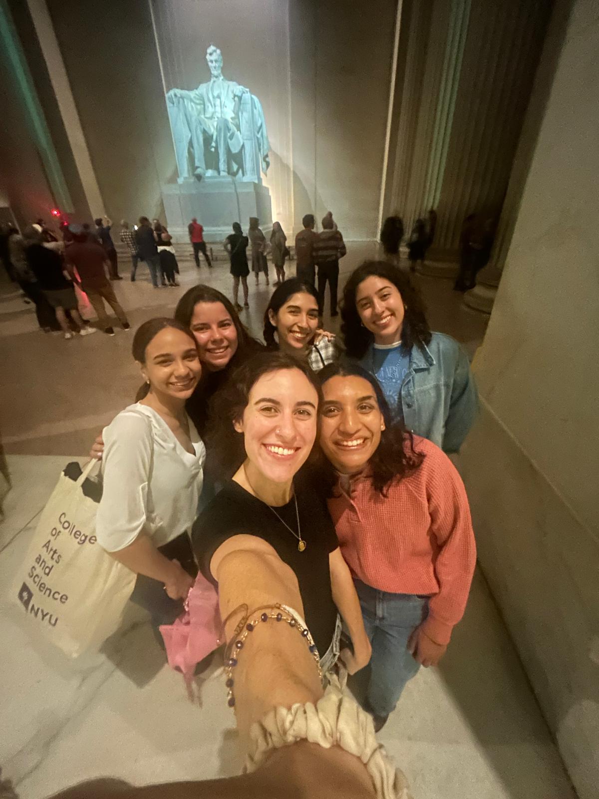 A group of students take a selfie in front of the Lincoln Memorial in Washington, DC.